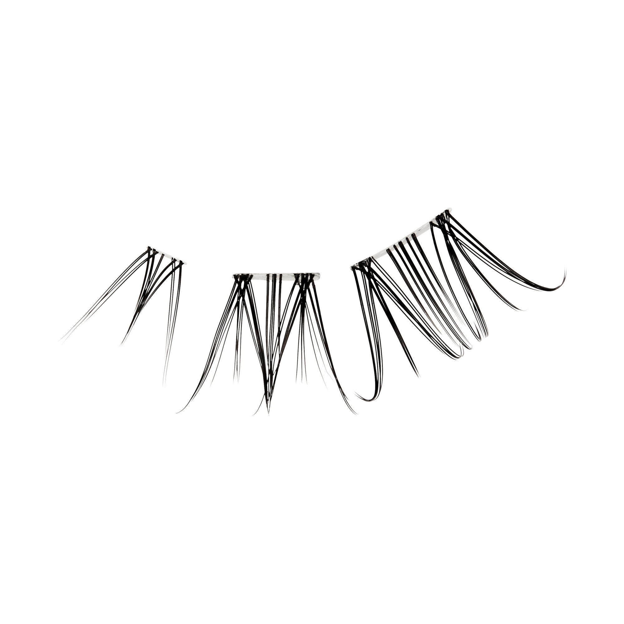The image features a set of false eyelashes arranged in a curved shape. The lashes are long and wispy, with varying lengths that create a dramatic effect. They are predominantly black, giving a bold appearance, and are designed to enhance the eyes by adding volume and length. The background is plain white, emphasizing the lashes&