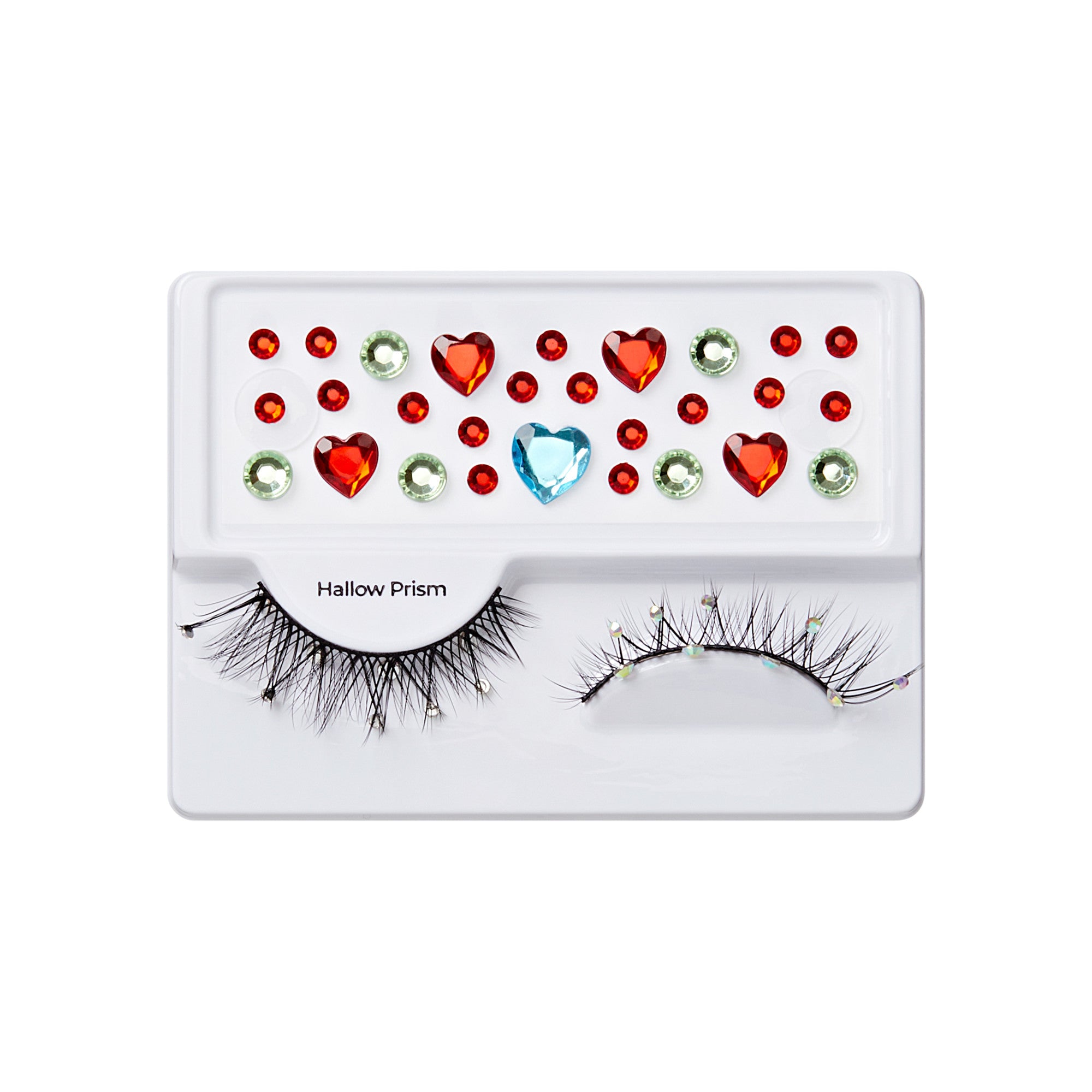 The image features a makeup product display that includes a pair of false eyelashes and an assortment of decorative gems. The eyelashes are long and wispy, designed to enhance the eyes. Above the lashes, there are various colorful gems arranged in a playful pattern, including red hearts, green rhinestones, and a blue heart-shaped gem. The overall presentation is vibrant and festive, suggesting a theme suitable for special occasions or creative makeup looks.