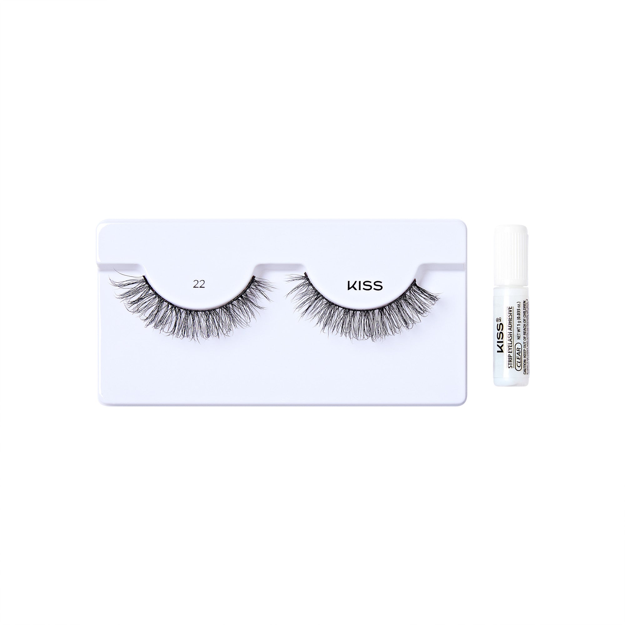 The image shows a set of false eyelashes from the brand "KISS." The eyelashes are displayed on a white plastic holder, with the number "22" printed above the left eyelash. To the right of the holder, there is a small tube of adhesive glue, also branded with "KISS." The eyelashes are voluminous and appear to be designed for a dramatic look.
