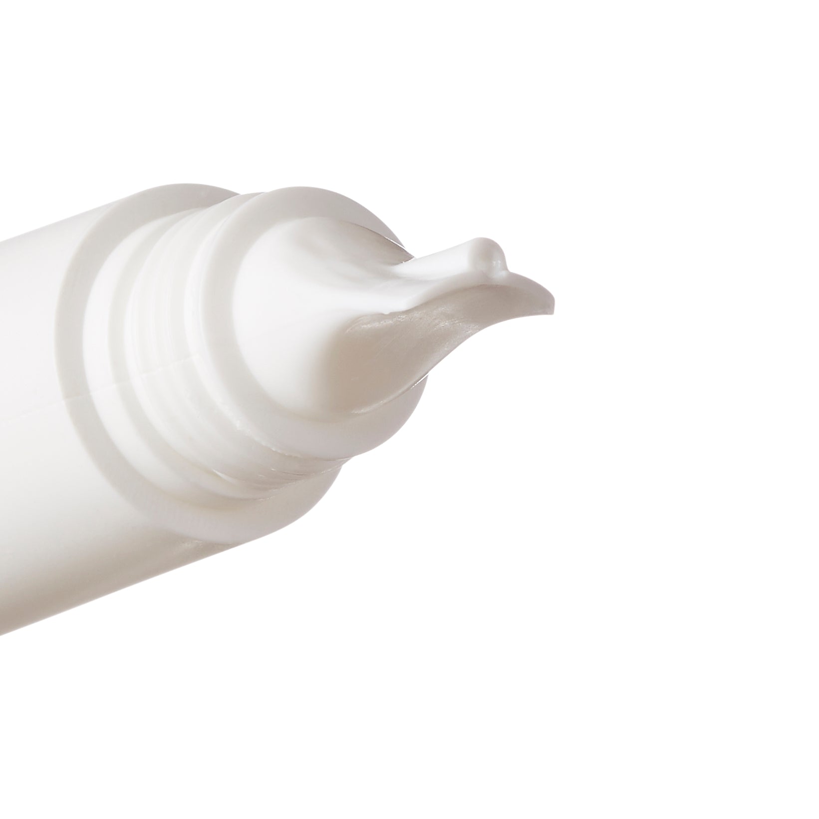 Close-up of a white tube applicator with a small amount of white cream on the tip, shown against a plain white background.