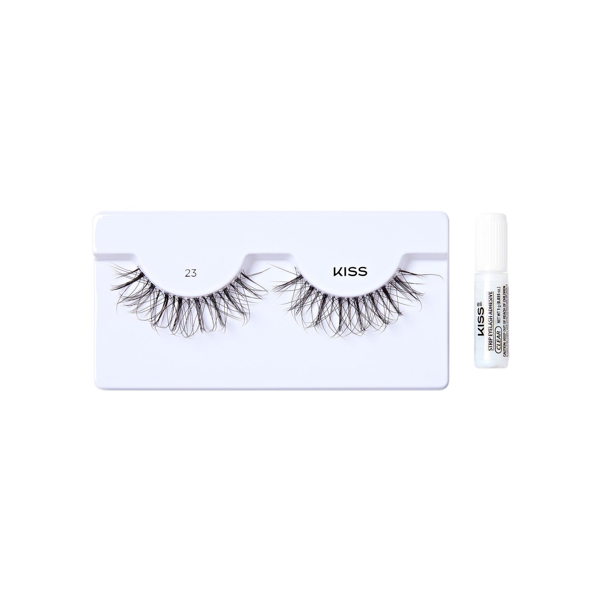 The image shows a set of false eyelashes from the brand "KISS." The eyelashes are displayed on a white plastic holder with the number "23" printed on it. To the right of the eyelashes, there is a small white tube of adhesive glue, also branded with "KISS." The overall presentation is clean and minimalistic, highlighting the product.
