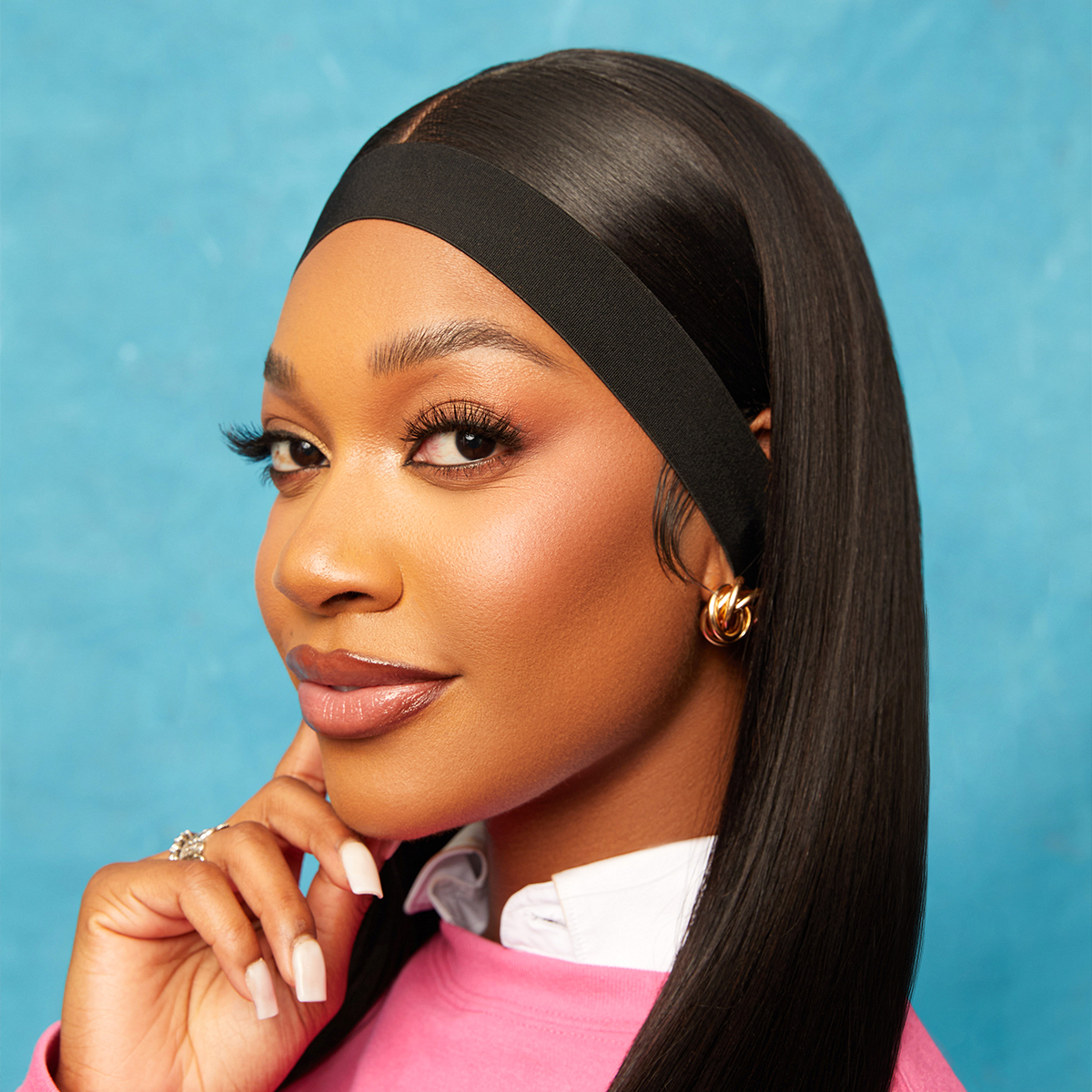 Close-up of a woman with smooth, straight black hair wearing a 1 3/4\