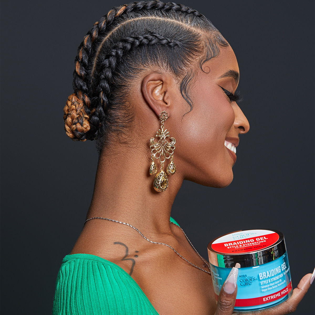 Woman with braided hair styled sleekly holds a blue jar of KISS Colors & Care Braiding Gel with red label reading \