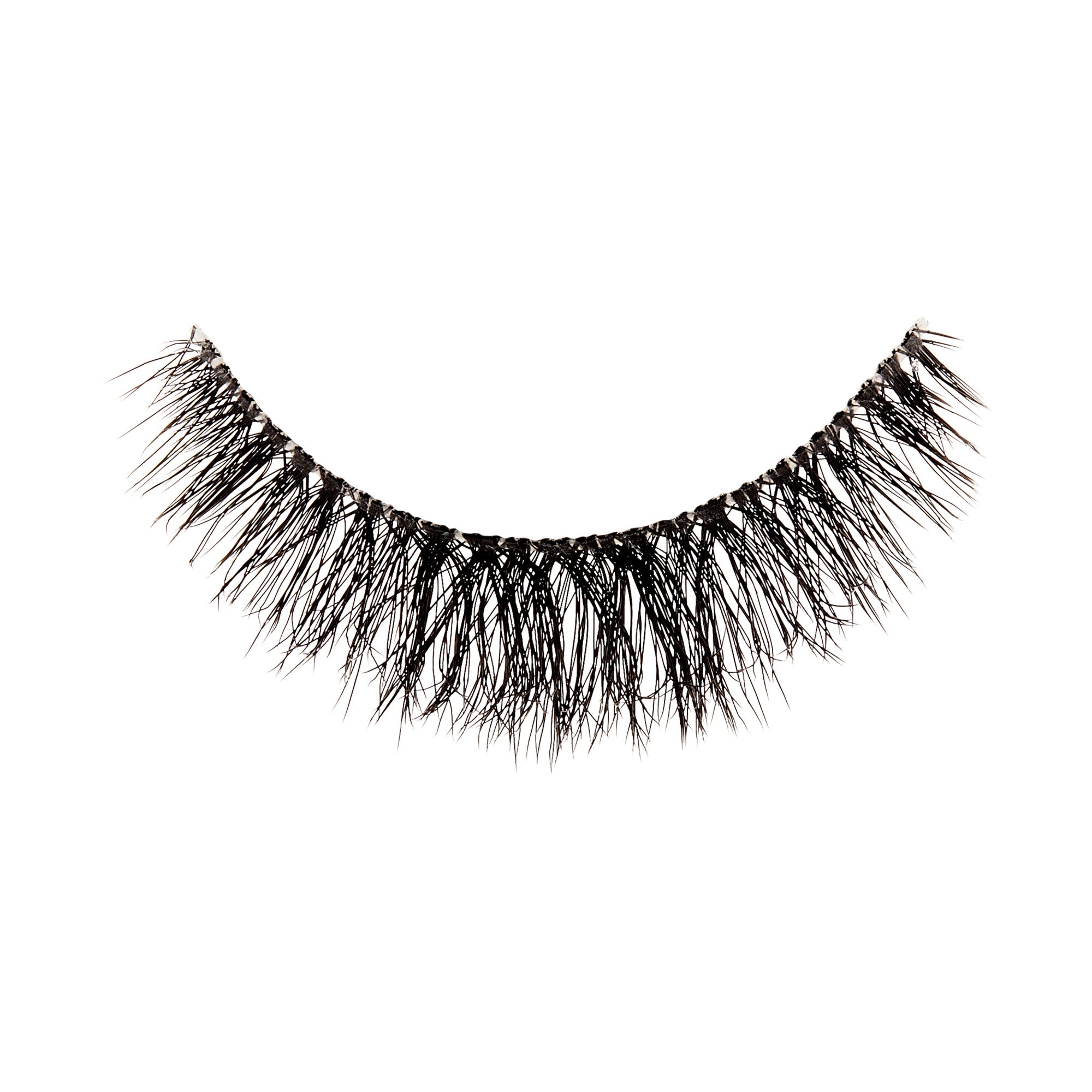 The image shows a single false eyelash. The eyelash is black and features a dense, wispy design with varying lengths of individual lashes, creating a voluminous and natural look. The base of the eyelash strip is slightly curved to fit the natural contour of the eyelid. The lashes are arranged in a way that they appear fuller at the base and taper off towards the tips.