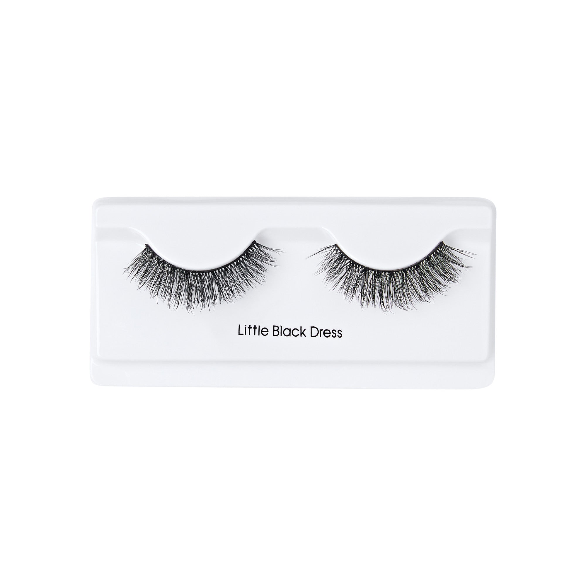 The image shows a pair of false eyelashes in a white plastic case. The eyelashes are thick and voluminous, with a natural curve. The case has a label that reads "Little Black Dress" positioned below the eyelashes. The overall presentation is clean and minimalistic.