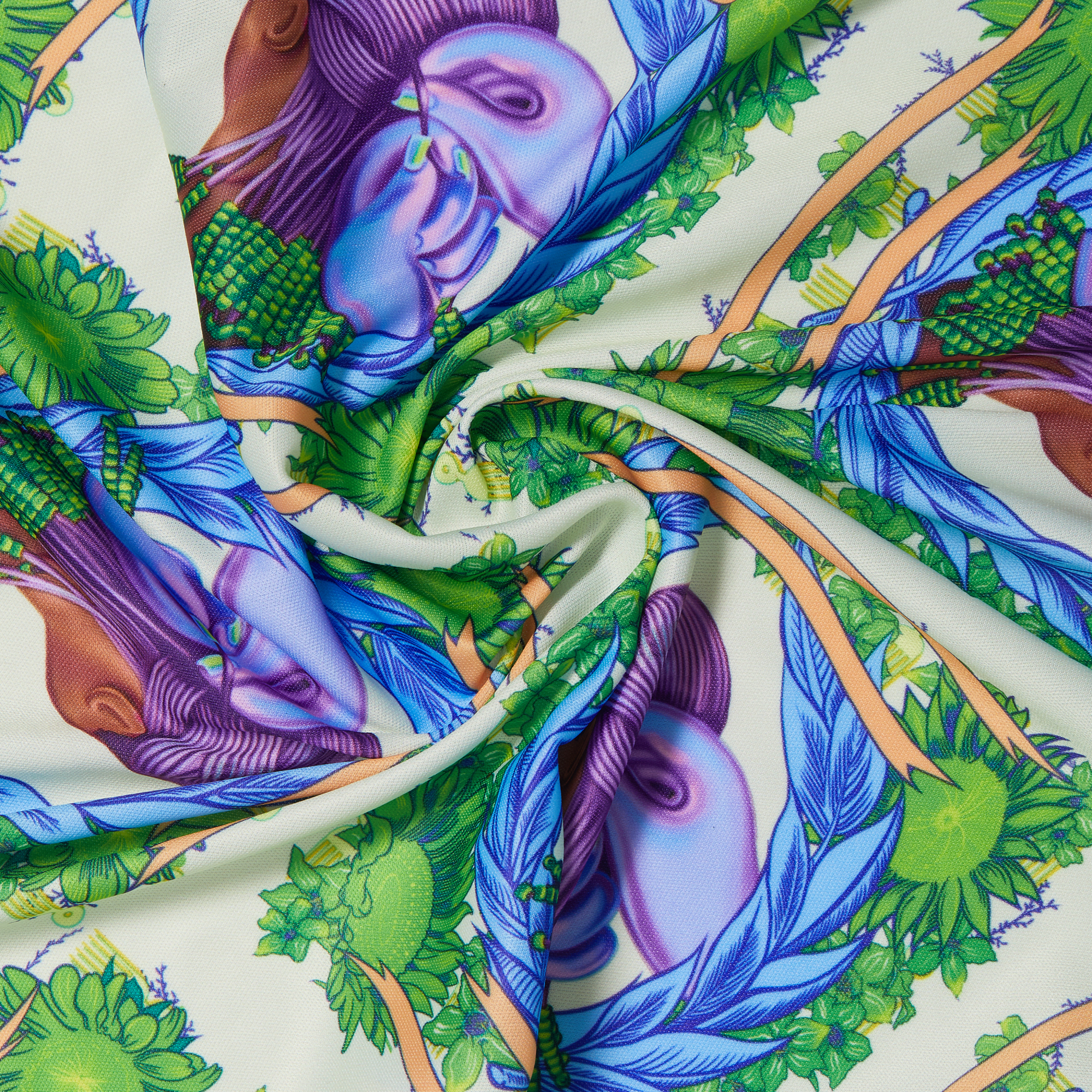 Satin wrap scarf with a vibrant design featuring purple faces, green foliage, and blue feathers on a cream background, folded in a swirl.