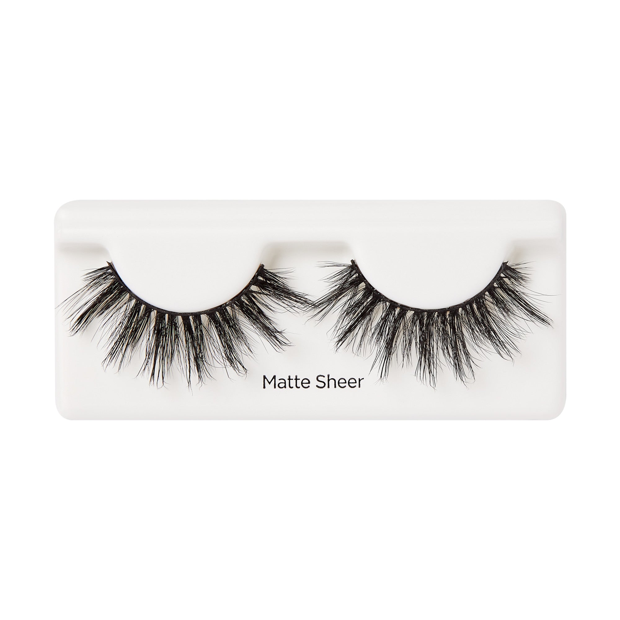 Pair of black false eyelashes with a matte finish, arranged on a white plastic tray labeled \