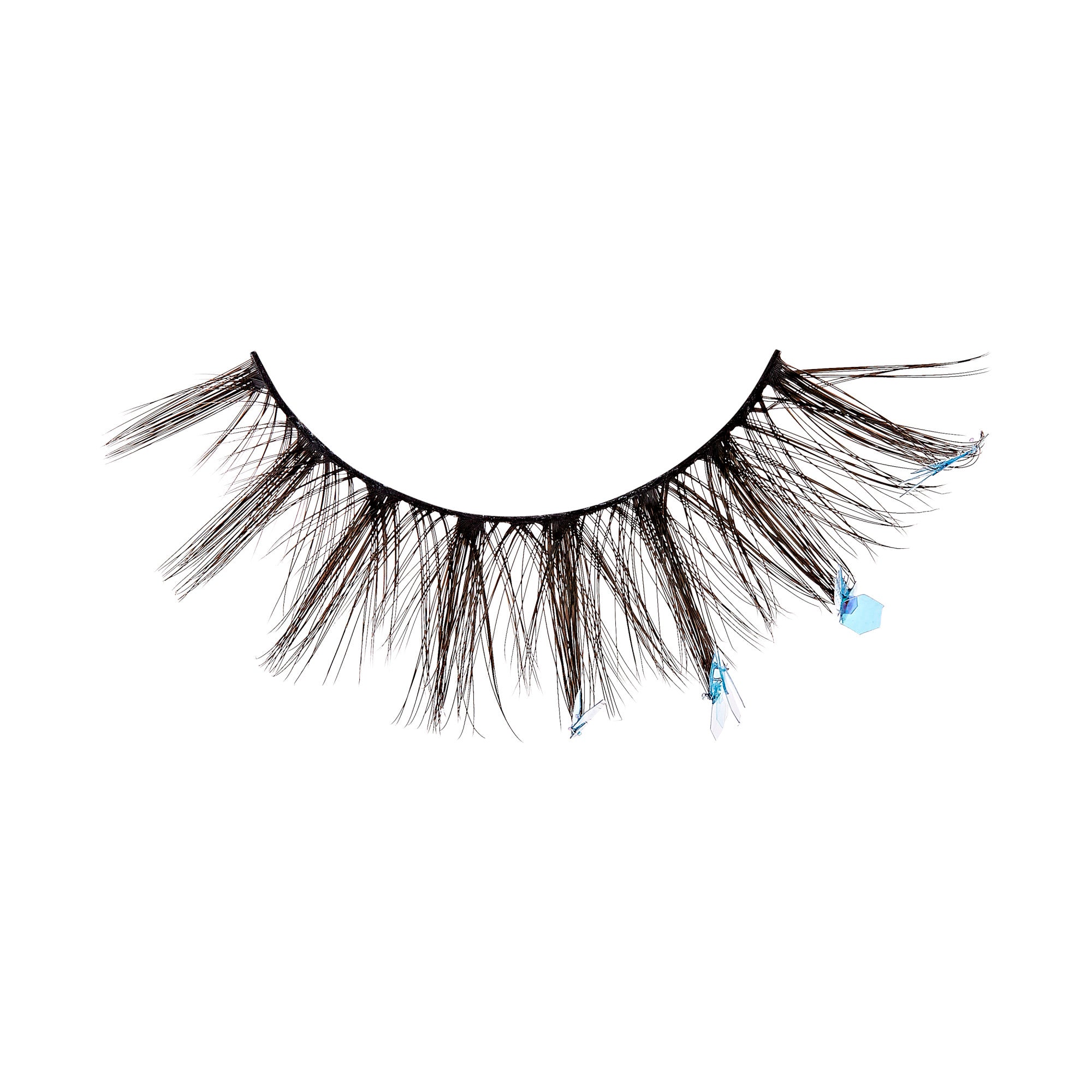 The image shows a single false eyelash. The eyelash is black and features a dramatic, voluminous design with long, wispy strands. Additionally, there are small, light blue decorative elements attached to some of the strands, adding a touch of color and sparkle to the overall appearance. The eyelash is curved to fit the natural shape of the eyelid.