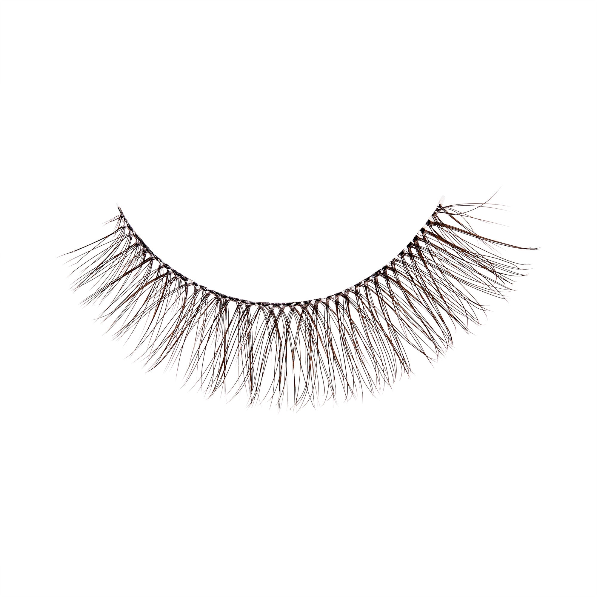 The image shows a single false eyelash. The eyelash is curved, mimicking the natural shape of the eye. It has a black band at the base where the individual synthetic lashes are attached. The lashes are long, wispy, and evenly spaced, giving a voluminous and fluttery appearance. The overall look is designed to enhance the fullness and length of natural eyelashes when applied. The background of the image is plain white, highlighting the details of the eyelash.