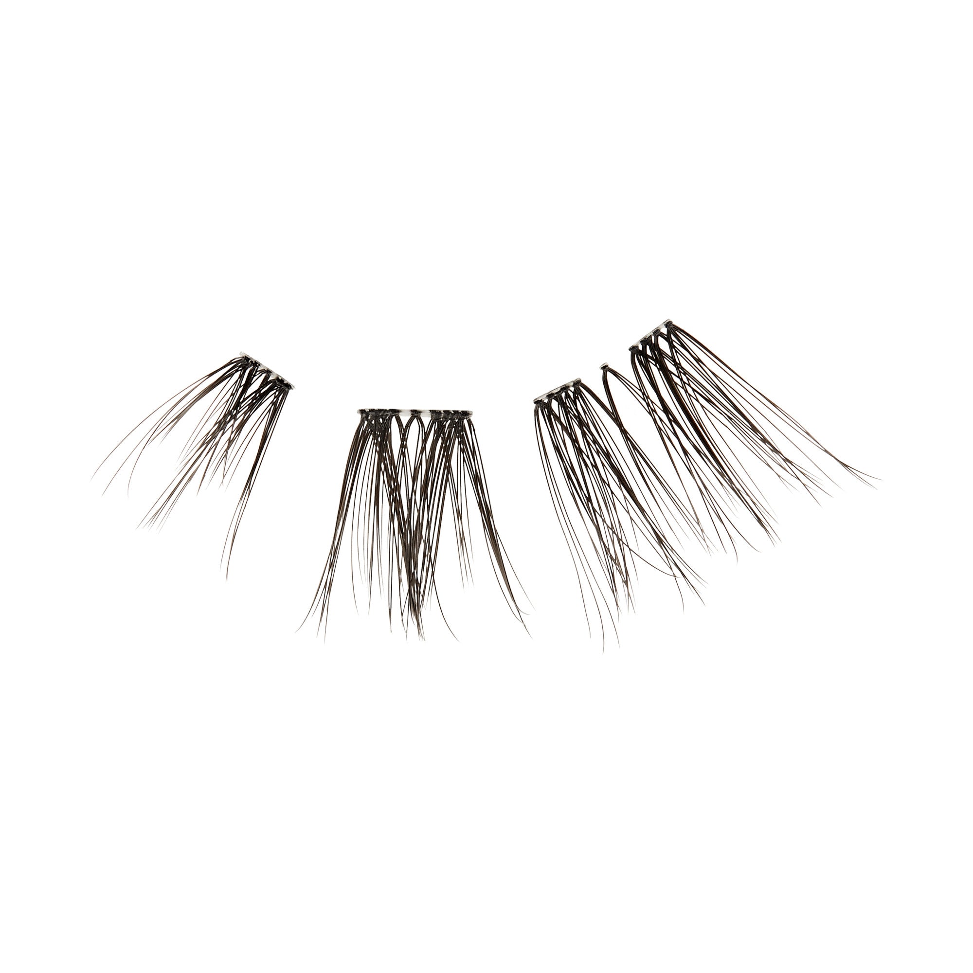 The image features a set of false eyelashes arranged in a fan-like shape. The lashes are black and vary in length, with some strands appearing longer and more pronounced than others. They are designed to enhance the appearance of natural eyelashes, providing volume and definition. The background is plain white, emphasizing the lashes&