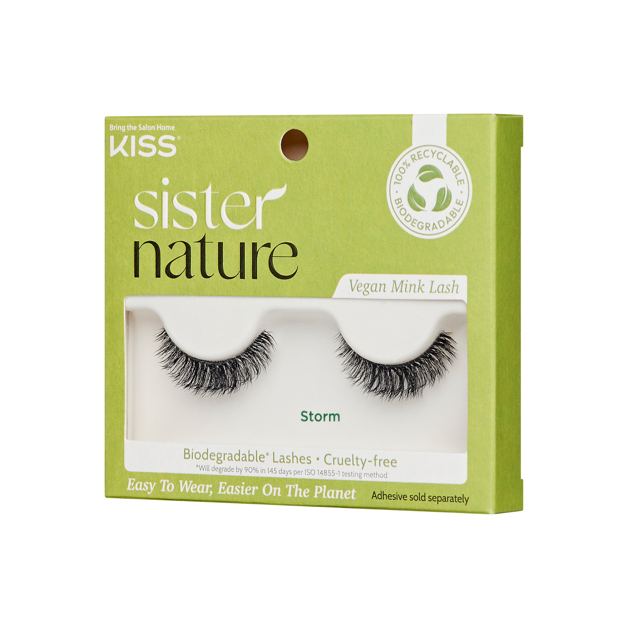 The image shows a product package for "KISS Sister Nature" vegan mink lashes. The packaging is predominantly green with white text. The lashes are named "Storm" and are visible through a clear window on the front of the package. The package highlights that the lashes are biodegradable and cruelty-free, made with 100% natural fibers. It also mentions that the packaging is 100% recyclable. The bottom of the package states, "Easy To Wear, Easier On The Planet," and notes that adhesive is sold separately.