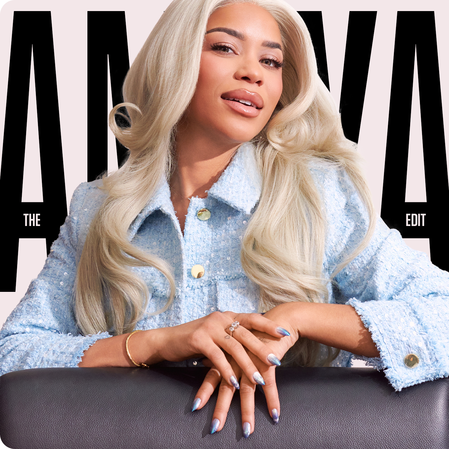 Woman with long blonde hair wearing a light blue denim jacket on a magazine cover with 'AMAYA' branding.
