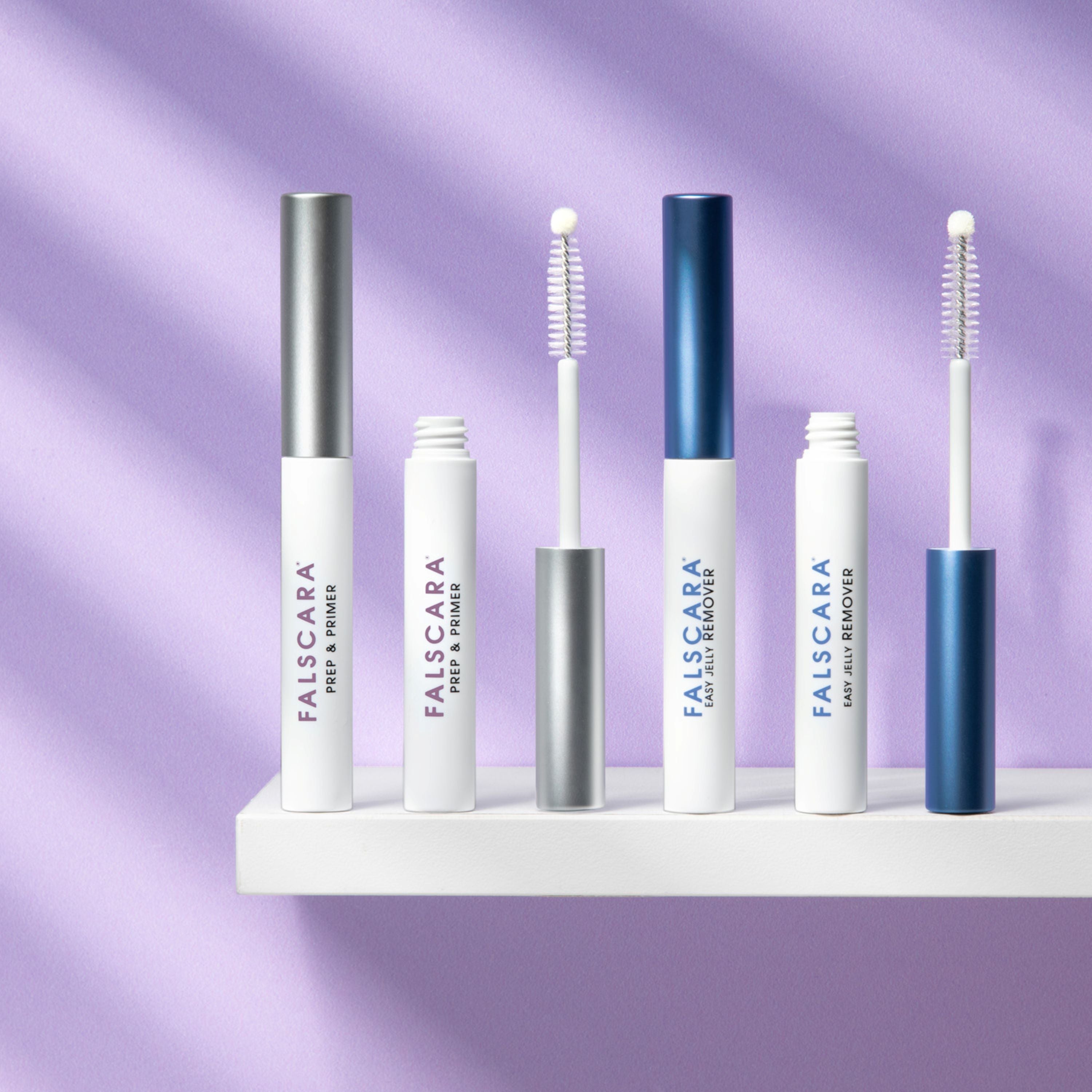 Set of Falscara false eyelash products on a white shelf with a purple background