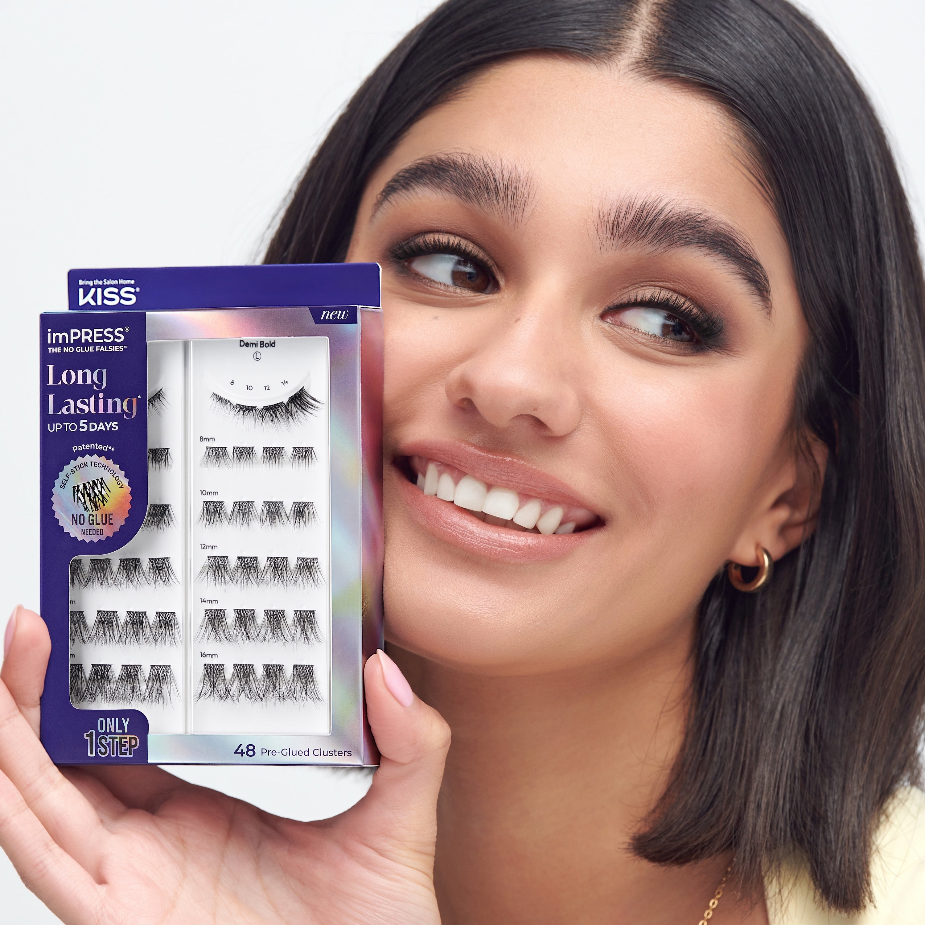Woman holding KISS imPRESS Long Lasting false eyelashes box with 48 pre-glued clusters