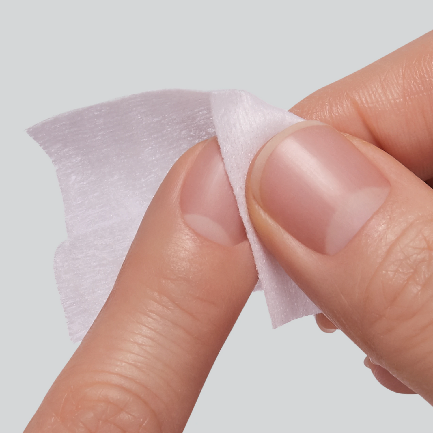 Close-up of nail being wiped with prep pad.