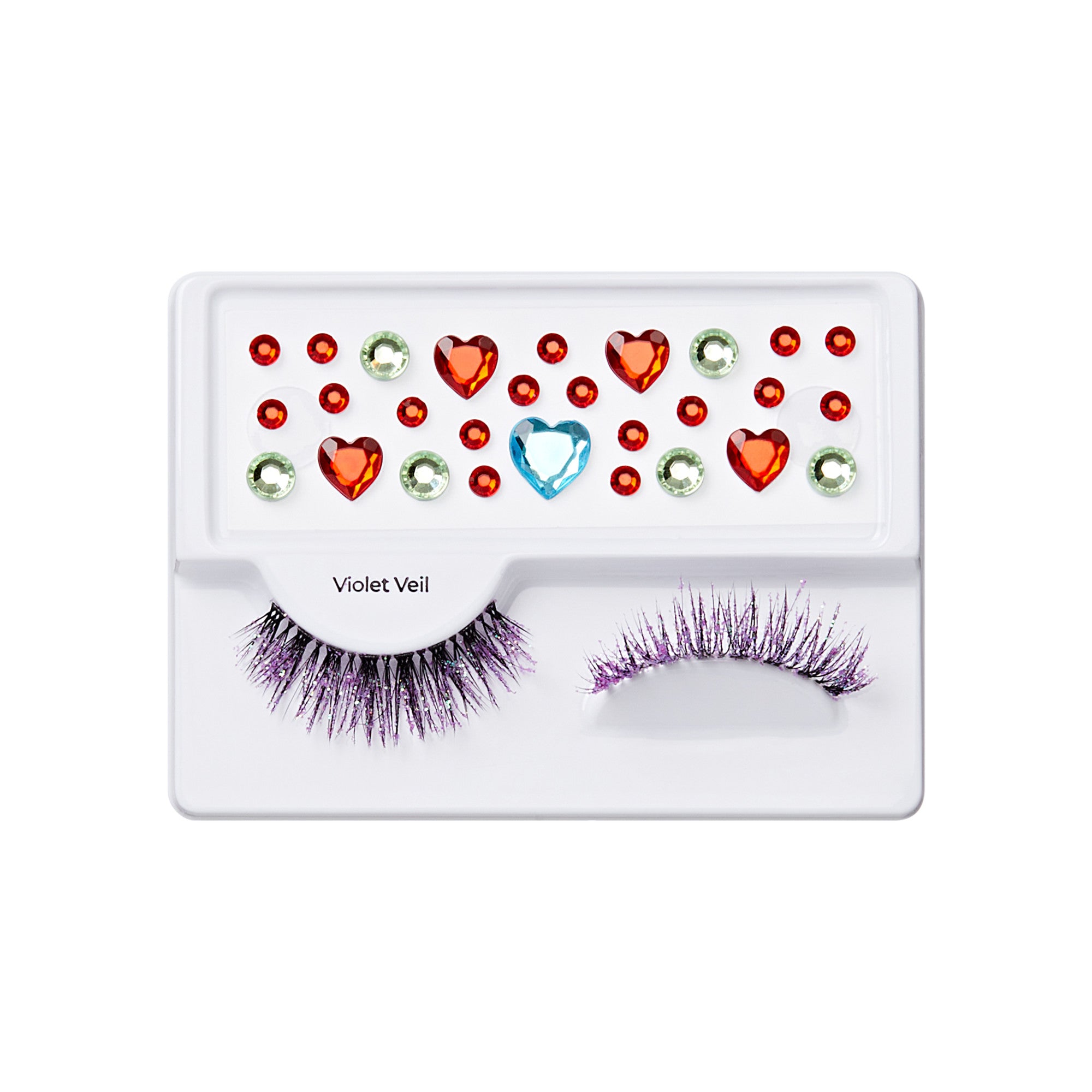 The image features a makeup product display that includes a pair of false eyelashes adorned with purple glitter. Below the lashes, there is a variety of decorative gems in different shapes and colors, including red hearts, green and clear rhinestones, and a blue gem. The overall presentation is vibrant and playful, suggesting a fun and creative approach to makeup. The product is labeled "Violet Veil.