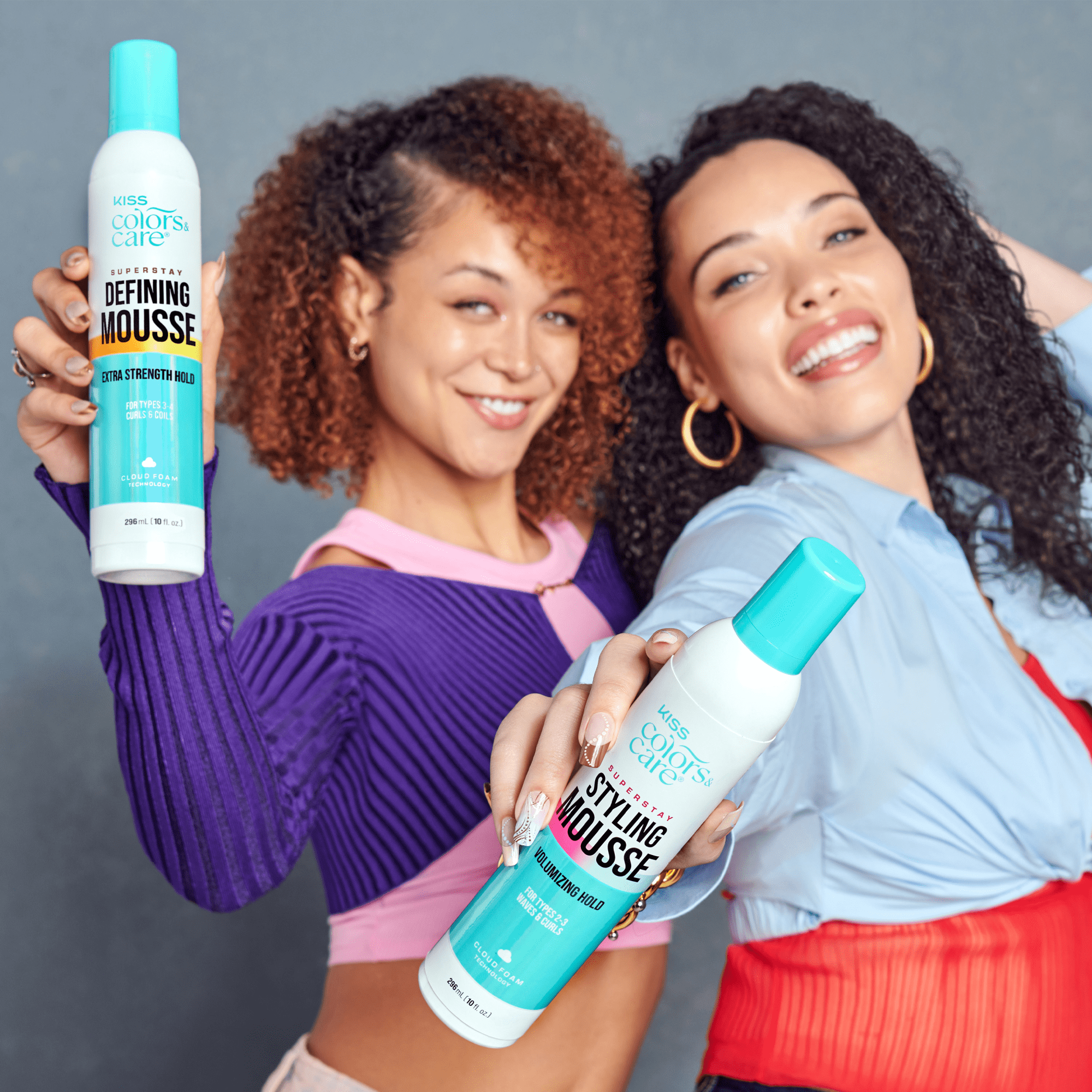 Two women holding bottles of &