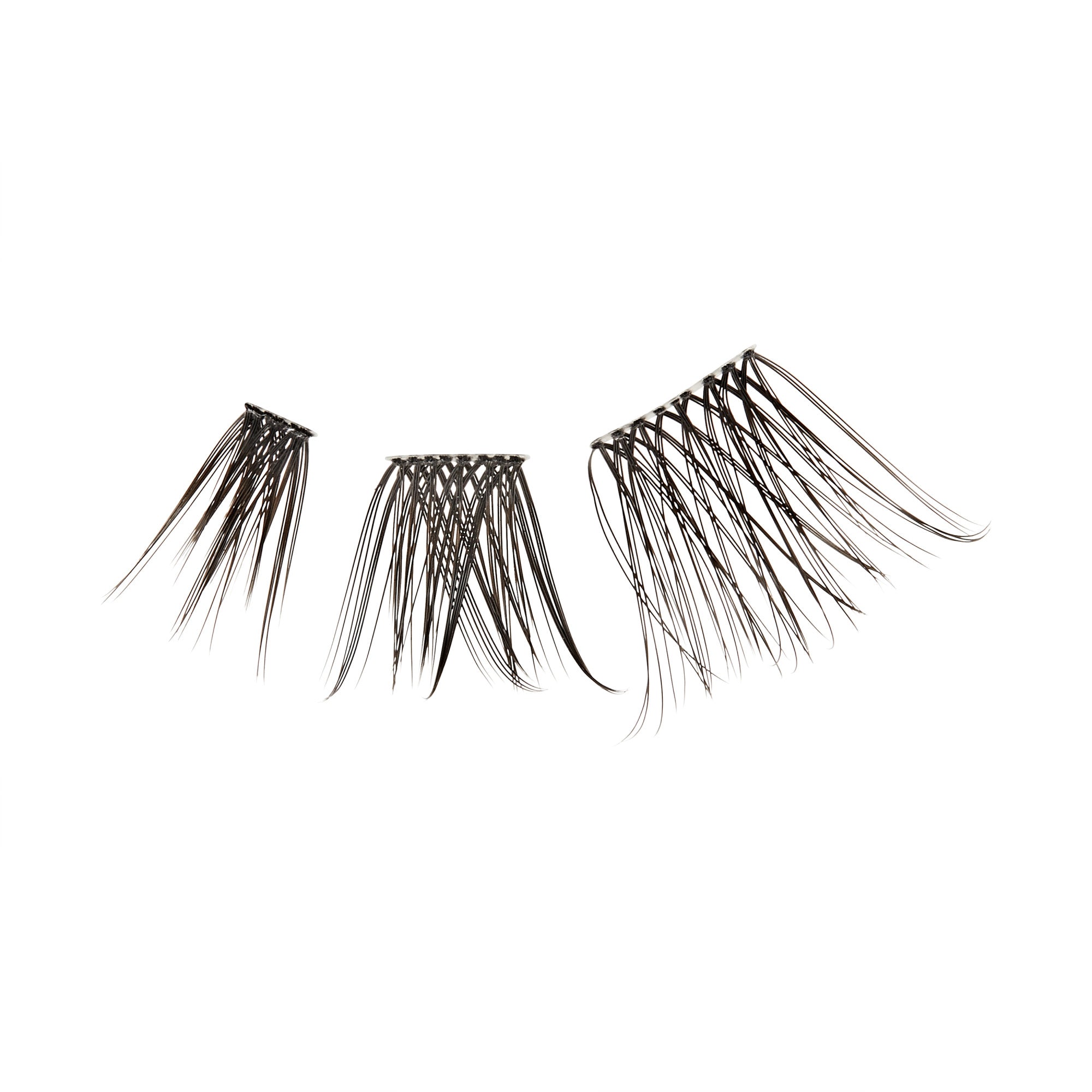The image features three sets of false eyelashes arranged in a row. Each set varies in size and style, with the lashes appearing long and wispy. The lashes are dark in color, likely black or deep brown, and are designed to enhance the eyes by adding volume and length. The background is plain white, emphasizing the lashes&