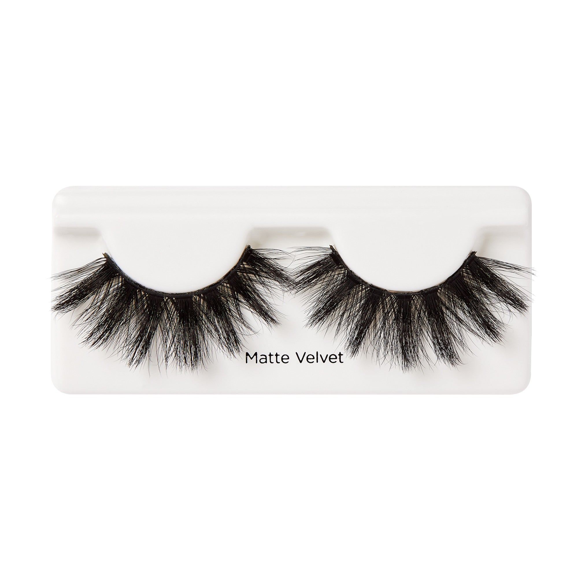 Pair of dense black false eyelashes with fluffy, separated clusters displayed on white tray labeled \