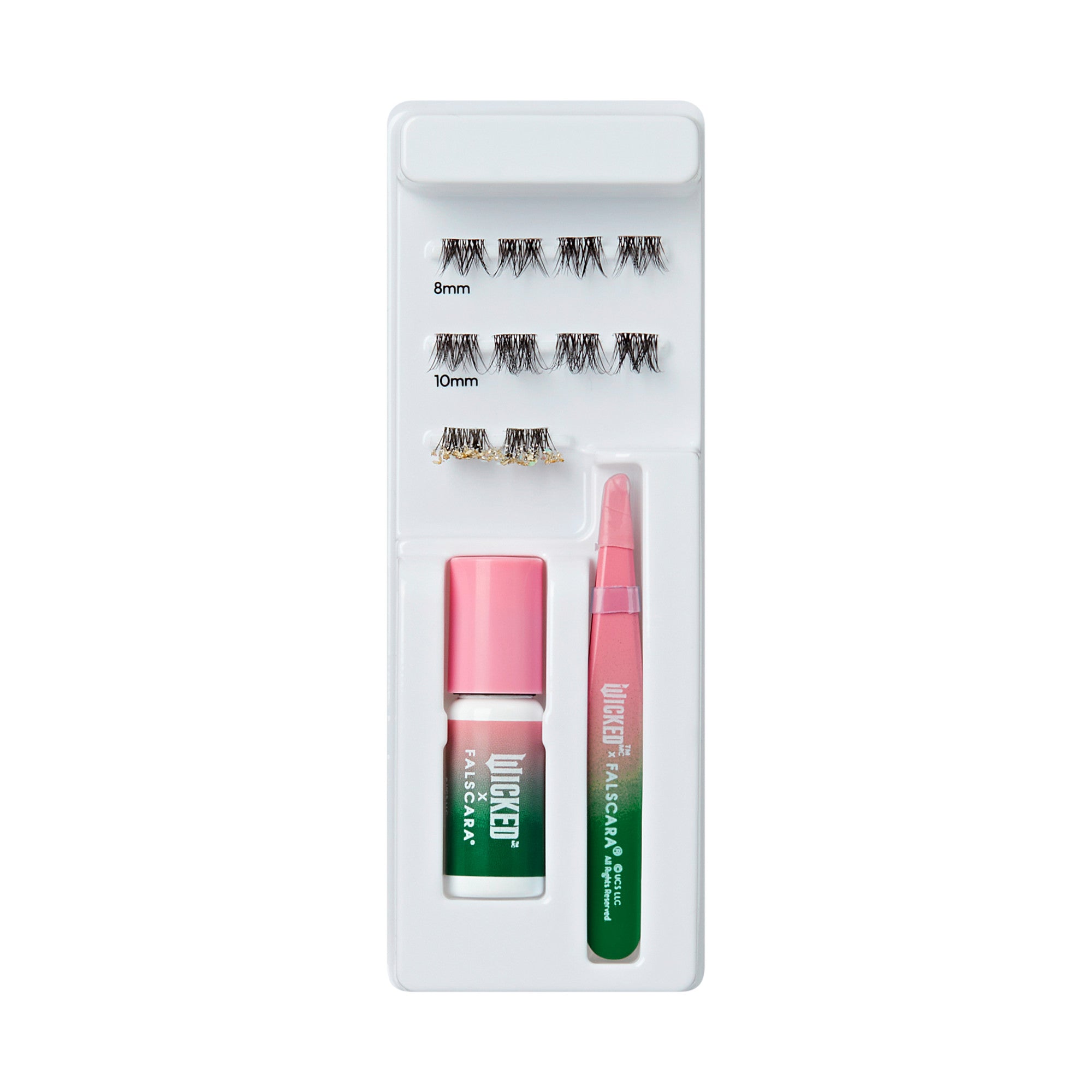 Falscara x Wicked false eyelash kit with three pairs of 8mm and 10mm lashes, pink and green adhesive bottle, and pink and green applicator tool.