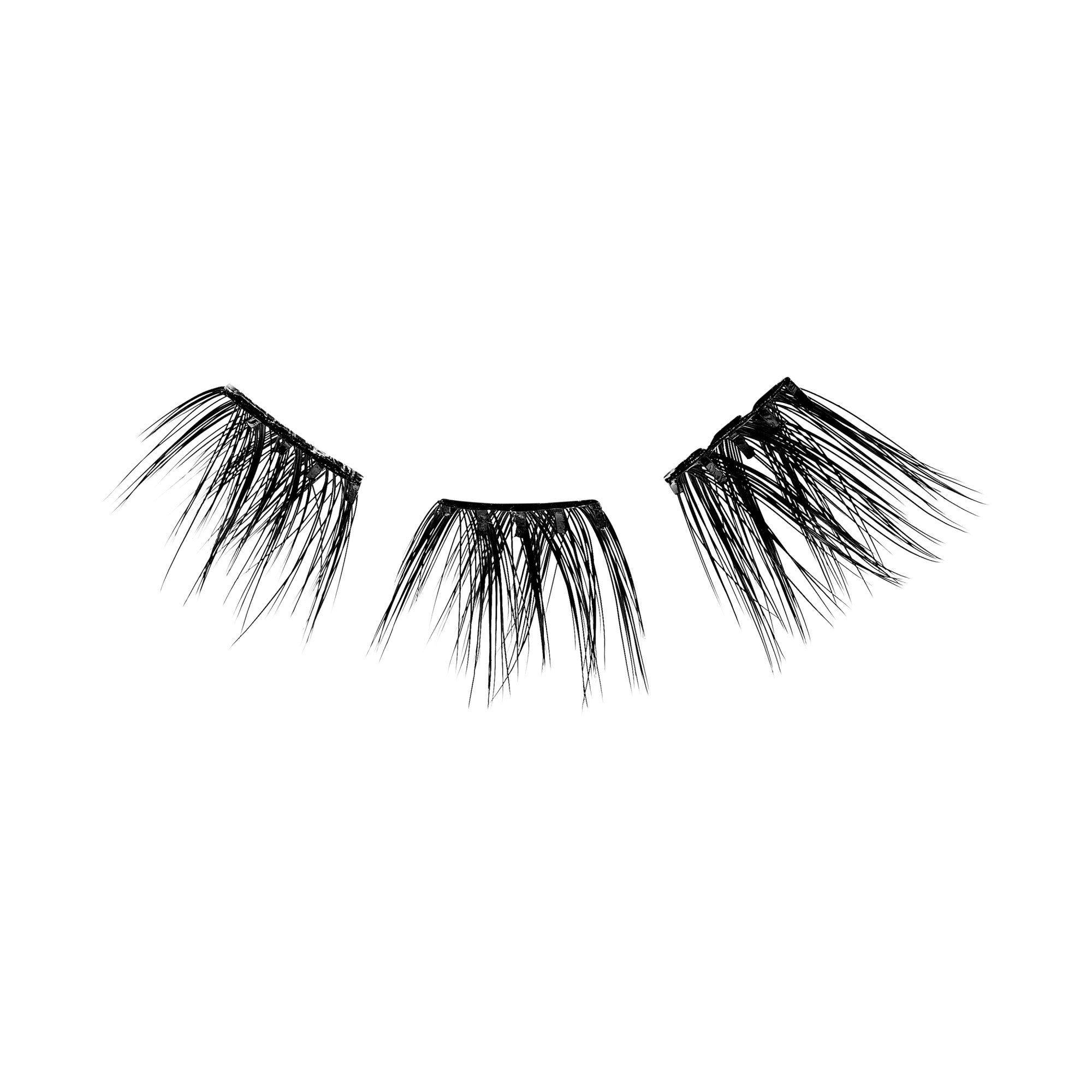 The image shows a pair of false eyelashes. The eyelashes are black and appear to be made of synthetic fibers. They are designed to be applied to the upper eyelid to enhance the appearance of natural eyelashes, making them look fuller and longer. The lashes are arranged in a semi-circular shape, mimicking the natural curve of the eyelid. The fibers are of varying lengths, with the longest ones towards the outer edges, creating a more dramatic effect.