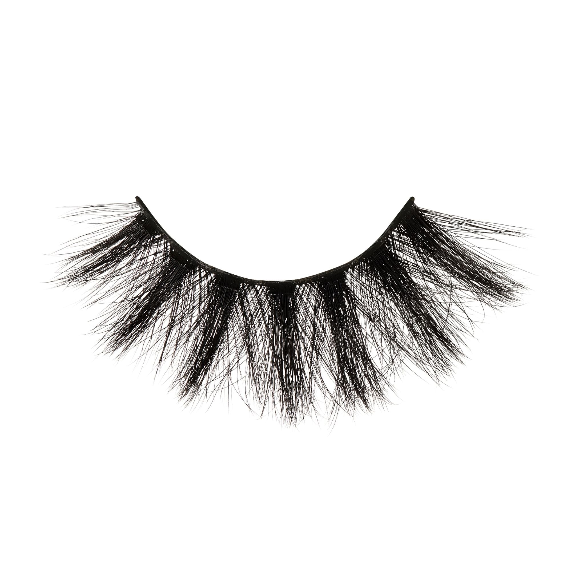 Single strip of KISS Lash Couture false eyelashes in matte black with a voluminous and wispy design against a white background.