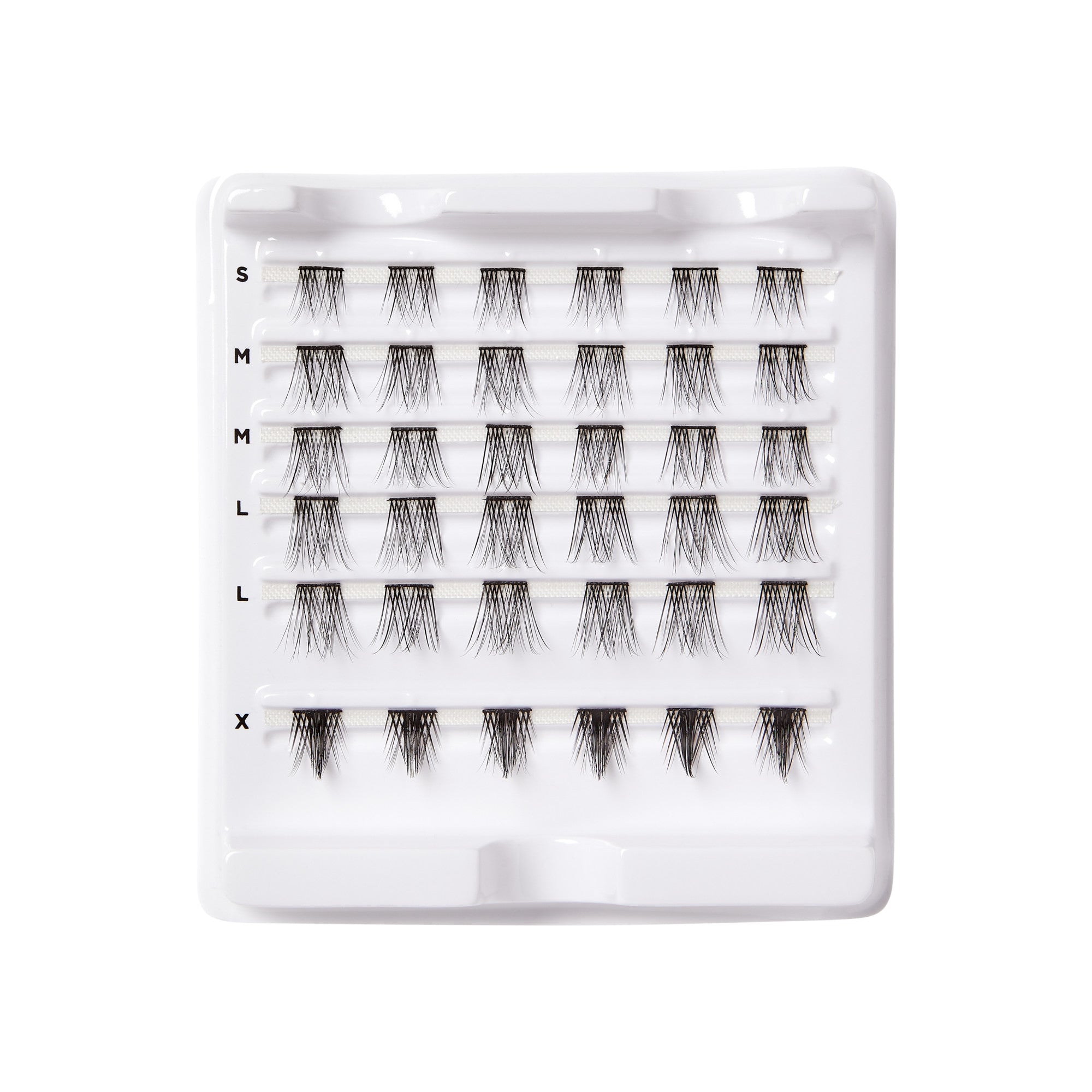 White plastic tray holding multiple clusters of black false eyelash wisps arranged in rows labeled S, M, L, and X, showing varying lengths and volume.