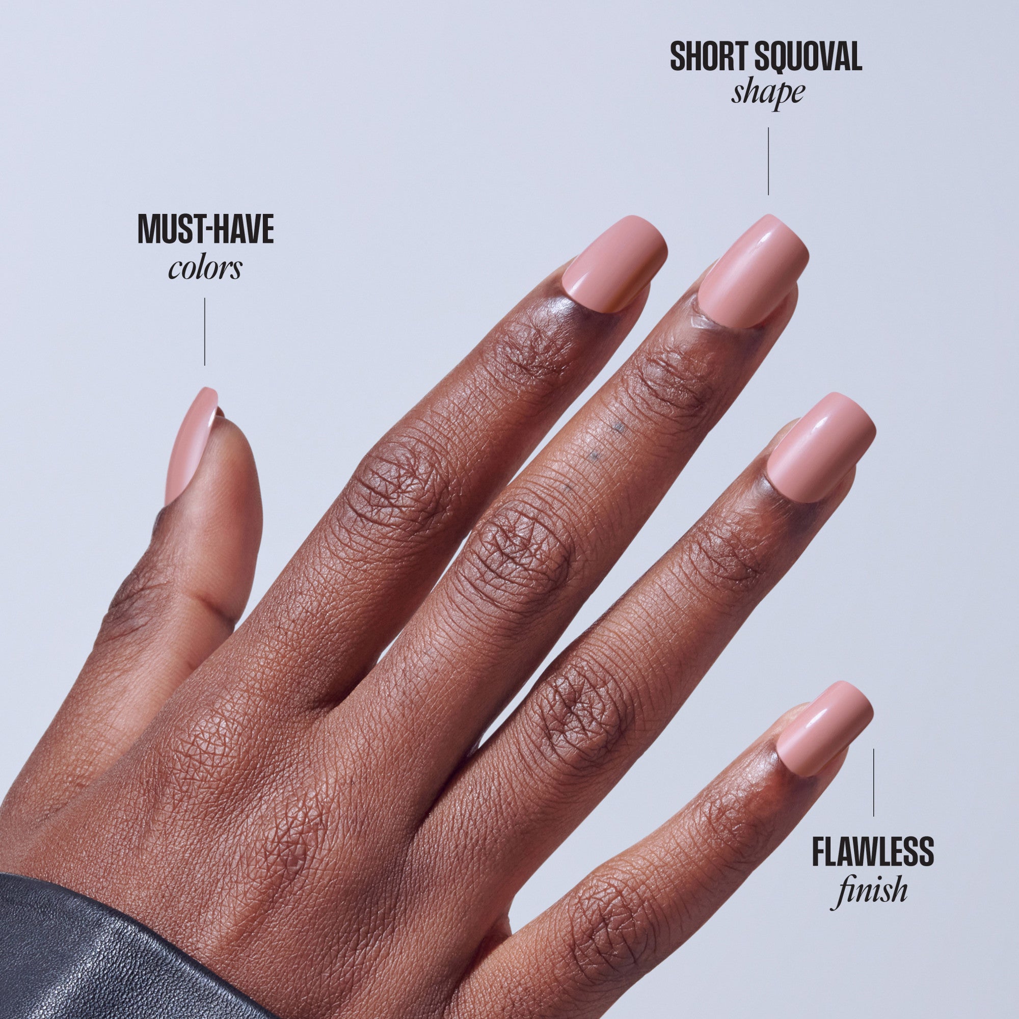 Short squoval nails in pink on deep skin tone showing shape and flawless finish.