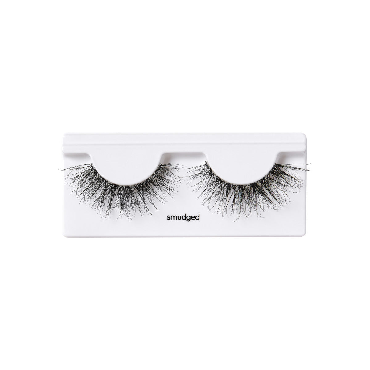 A pair of KISS Rebel Couture false lashes in the style, Smudged shown outside of the packaging