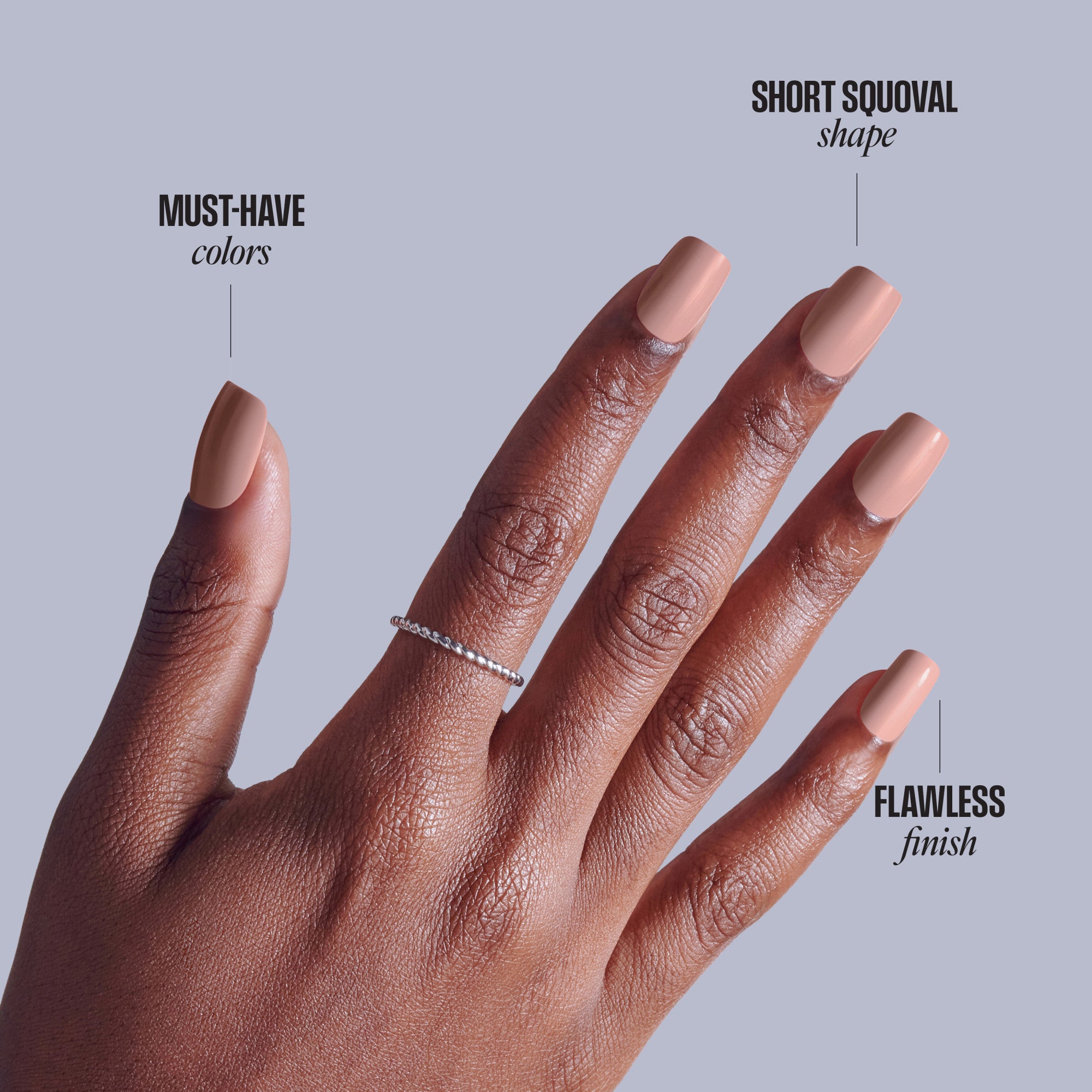 Short squoval manicure showcasing nude pink nails on deep skin tone hand with diamond ring.