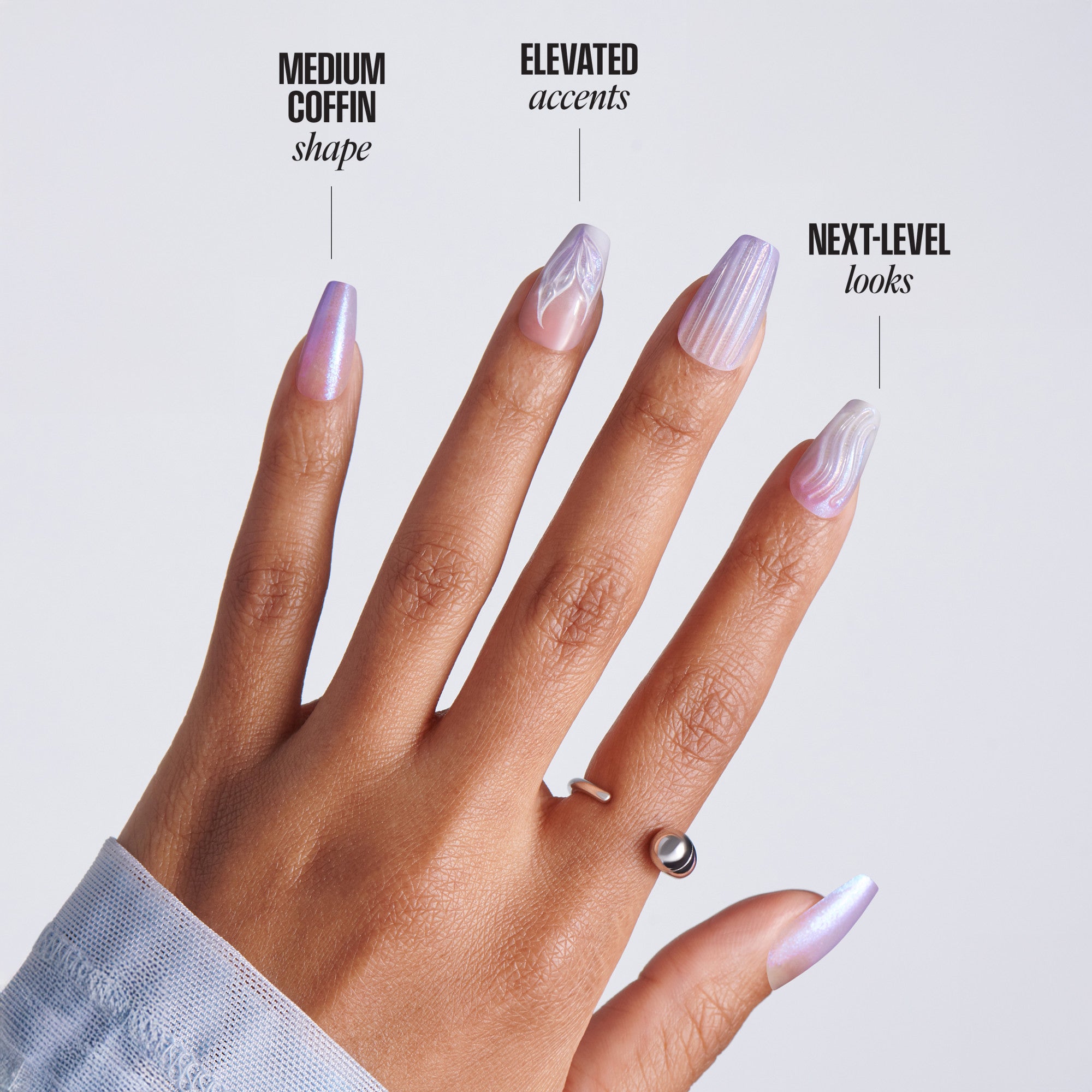 Hand with medium coffin-shaped lavender pearl ombre press-on nails with swirl designs and silver ring, with text: Medium Coffin Shape, Elevated Accents, Next-Level Looks