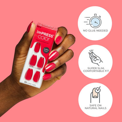 Hand with bright red press-on nails holding imPRESS Color press-on manicure pack showing coffin-shaped nails, with text highlights: No glue needed, super slim comfortable fit, safe on natural nails.