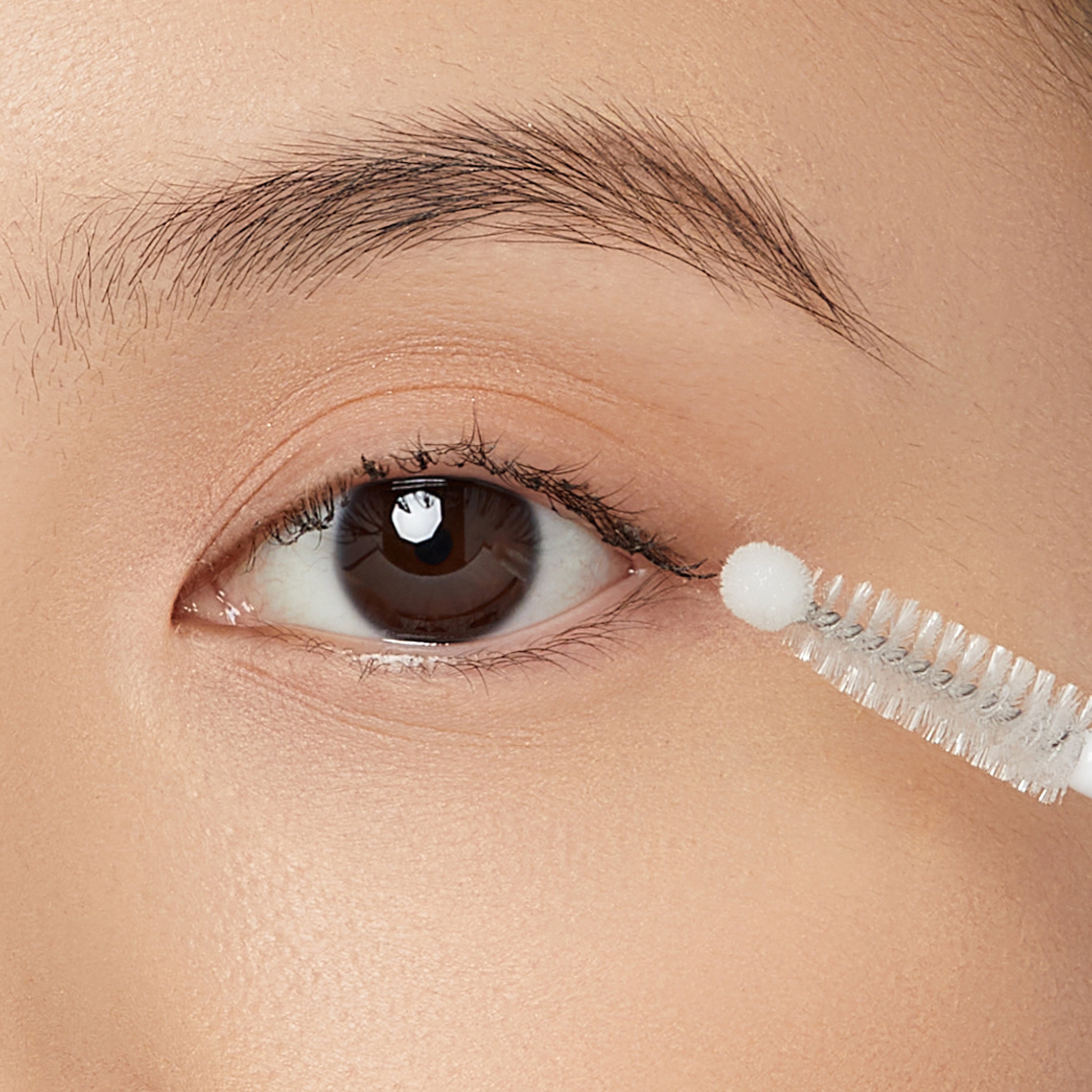 Eyelash curler being used on a person&