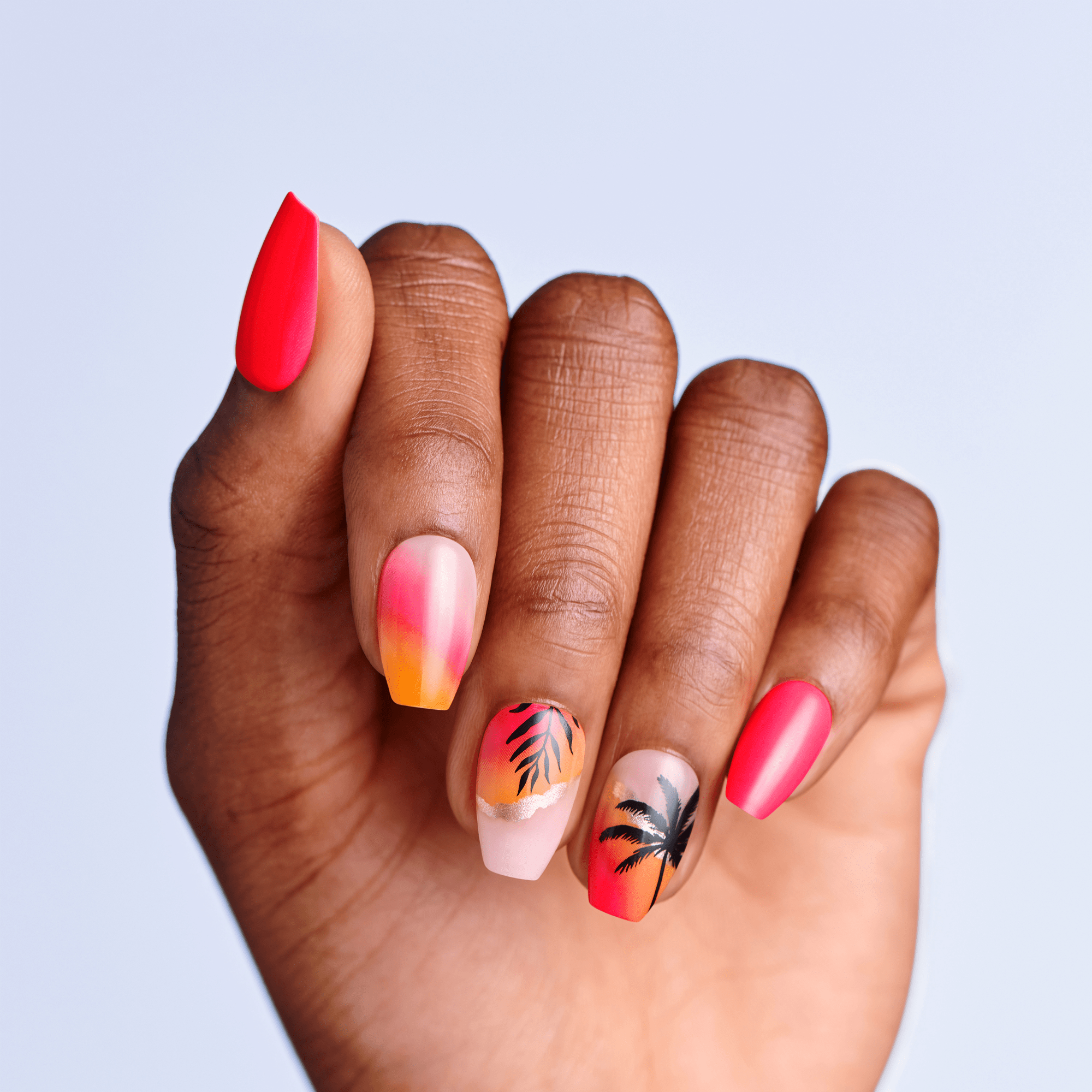 Hand with colorful nail art on a light purple background