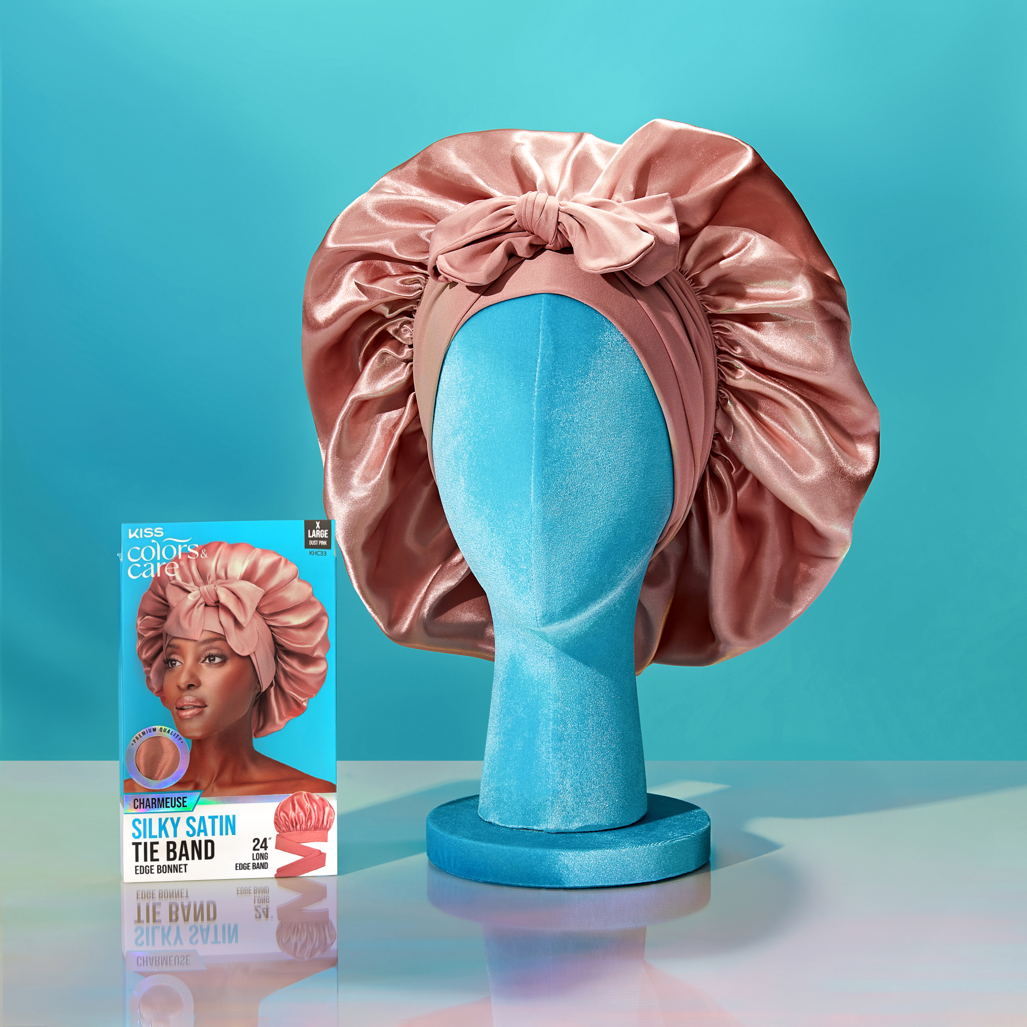 Silky satin tie-back hair accessory on a mannequin head with product packaging in the background.