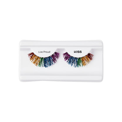 The image shows a pair of false eyelashes in a white plastic case. The eyelashes are multicolored, featuring a rainbow gradient with colors including red, orange, yellow, green, blue, and purple. The left eyelash is labeled "Live Proud," and the right eyelash is labeled "KISS." The eyelashes have a dramatic, voluminous appearance with a spiky texture.