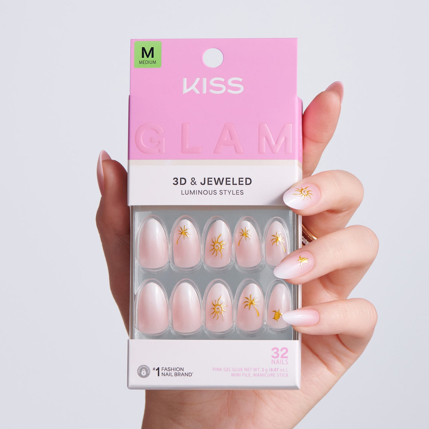 Kiss Glam 3D &amp; Jeweled nail art packaging held by a hand with matching nails.