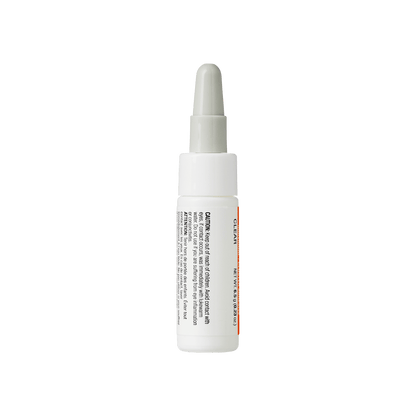Clear spot treatment serum bottle with dropper applicator and orange accent stripe