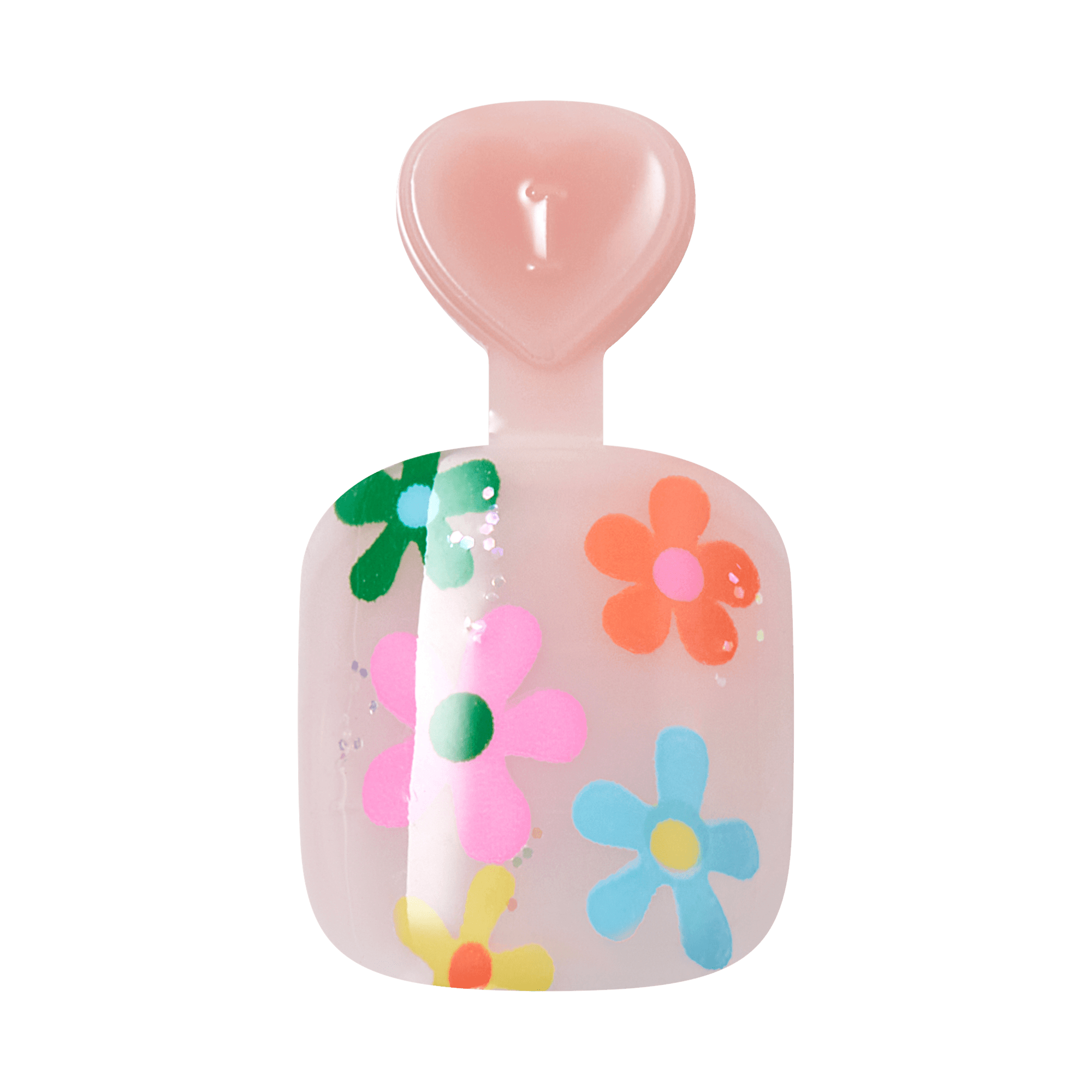 Pink heart-shaped candle with colorful flower designs and lit wick.