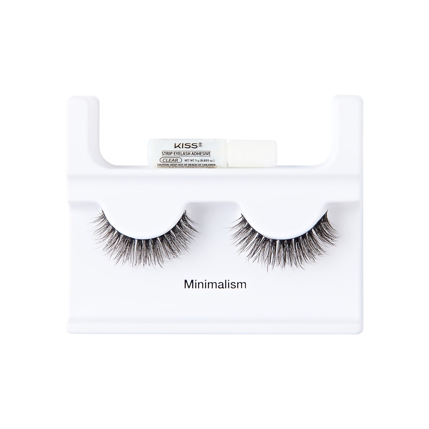 The image shows a set of false eyelashes displayed on a white holder. The holder has a minimalist design and features the word "Minimalism" printed on it. Above the eyelashes, there is a small tube of adhesive labeled "KISS Strip Lash Adhesive." The eyelashes are full and voluminous, with a natural-looking gradient from shorter to longer lashes. The overall presentation is clean and simple, emphasizing the minimalist theme.