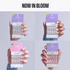 Four hands holding packages of Kiss nail art designs against a light gray background.