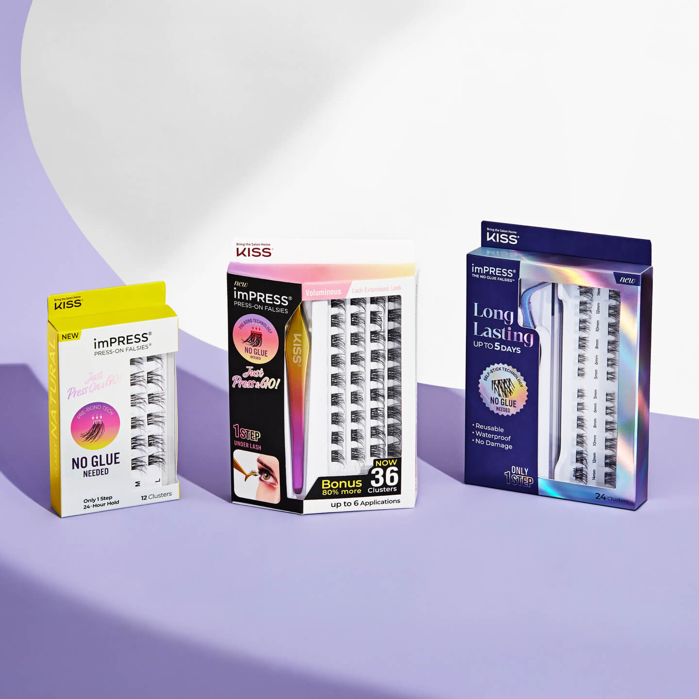 Three imPRESS Press-On Falsies lash kits displayed upright on a purple and white background. The packaging reads “No Glue Needed” and features styles like Natural, Voluminous, and Long Lasting. Each box displays lash clusters with vibrant branding and bonus applications.