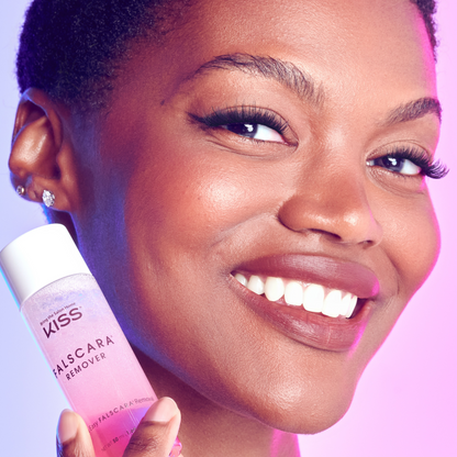 Woman holding a bottle of Kiss Falscara Remover with a close-up of her face.