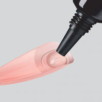 Close-up of Salon X-tend Gel Adhesive being applied to an artificial nail.