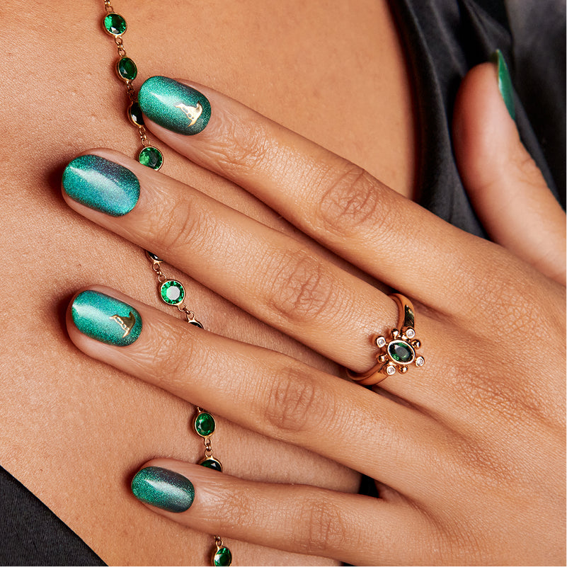 Emerald green shimmer manicure with matching bracelet and ring jewelry.