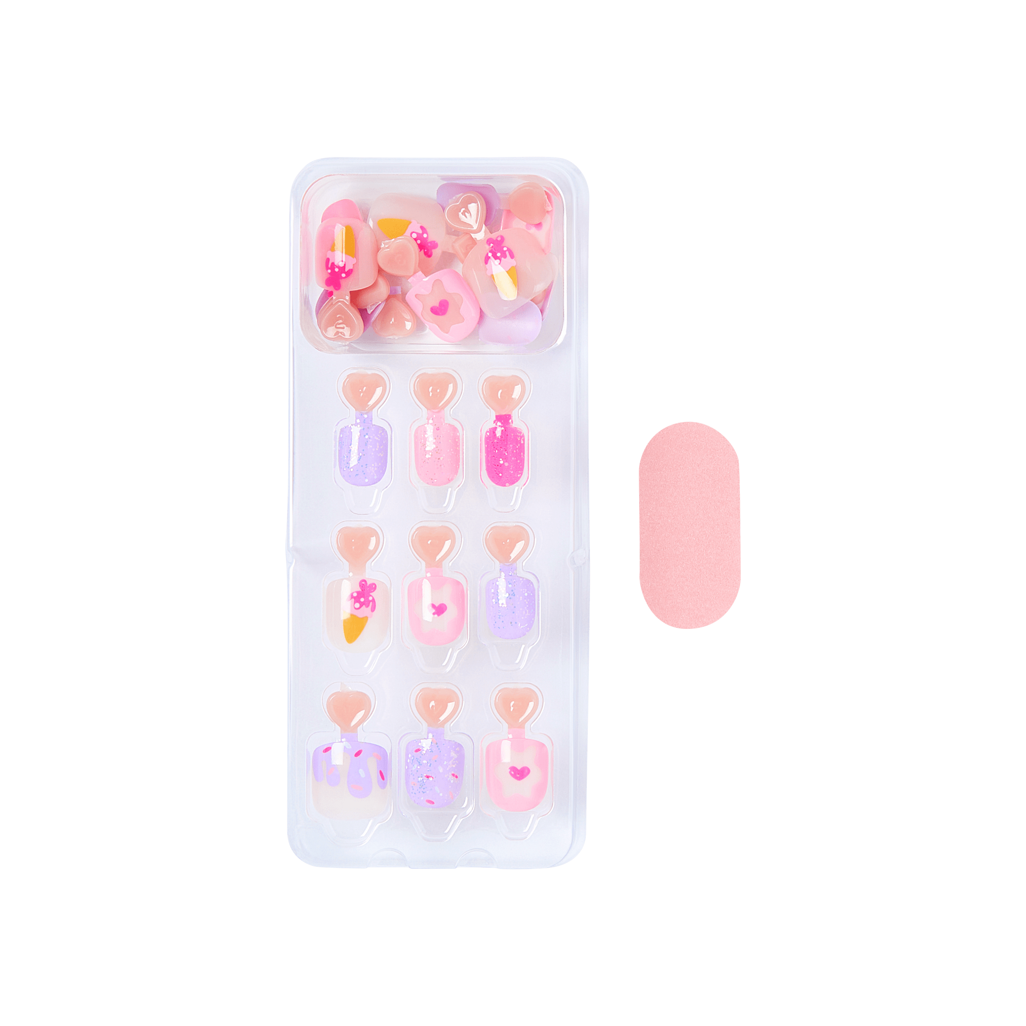Set of small pink nail art decorations in a clear plastic case on a green background