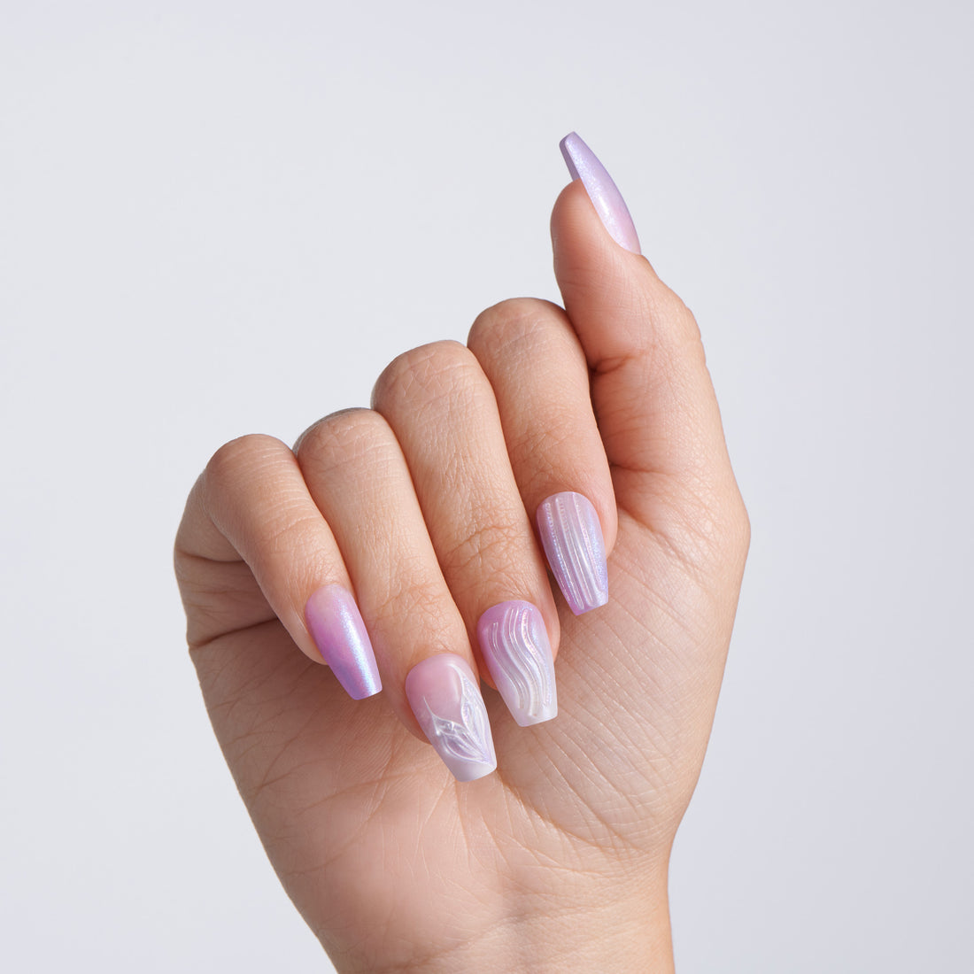 Hand with pink nail polish on a light gray background