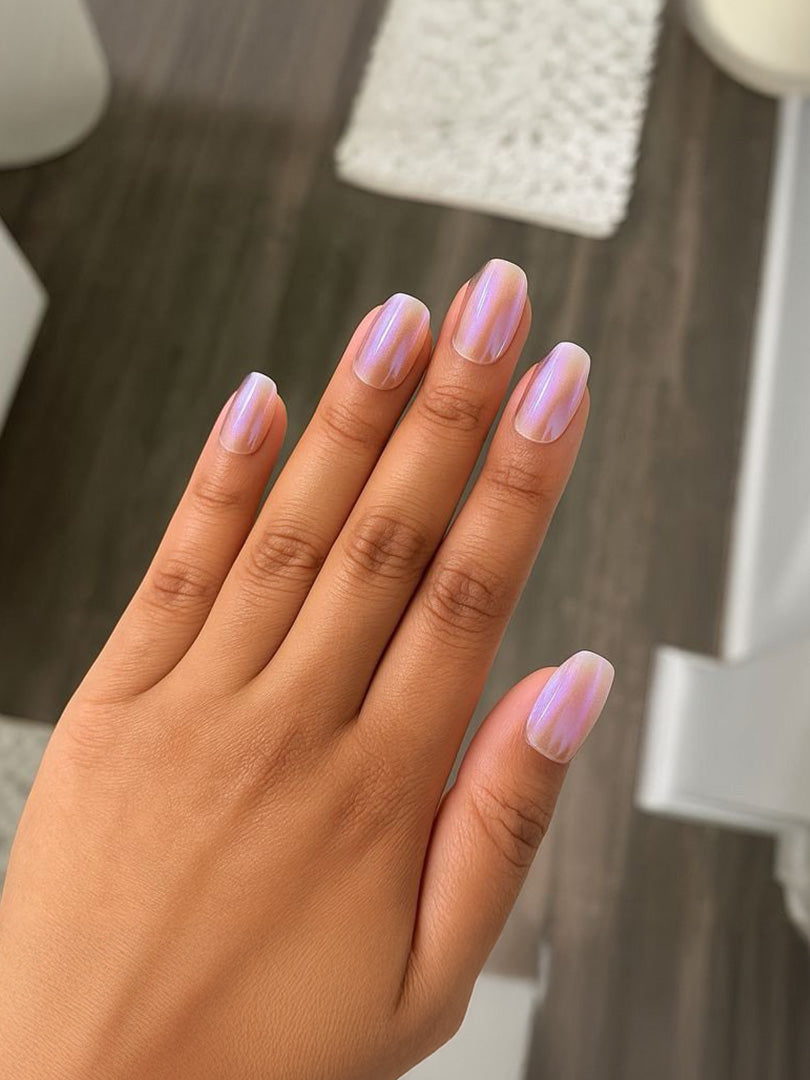 Iridescent pearl pink manicure with vertical shimmer stripes on natural nails.