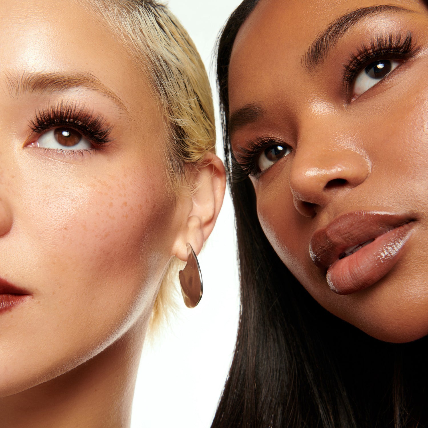 Two women with close-up faces on a white background