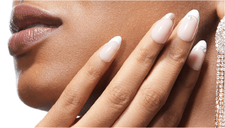 Close-up of a woman's nails that are almond shaped with natural coloring and designs on the tips